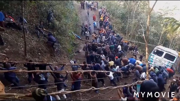 Villagers pull truck from a 70 foot gorge