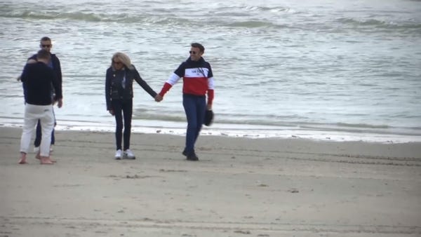 Macron and his wife walk along Le Touquet beach