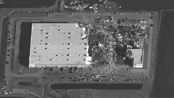 Aerial view of warehouse damaged by tornado