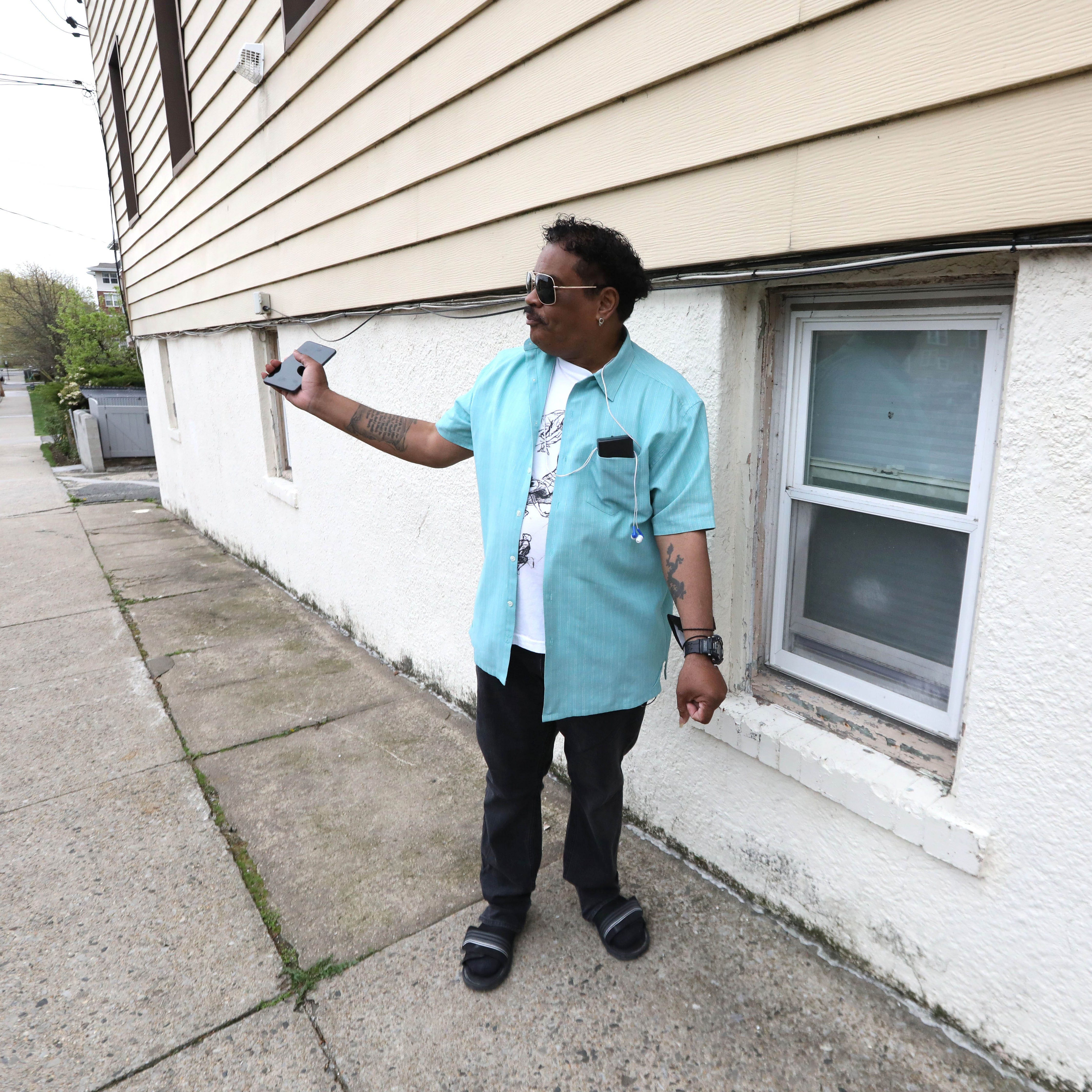 Standing beside the window he escaped from, Randy Scott recounts how his block was flooded from Hurricane Ida.
