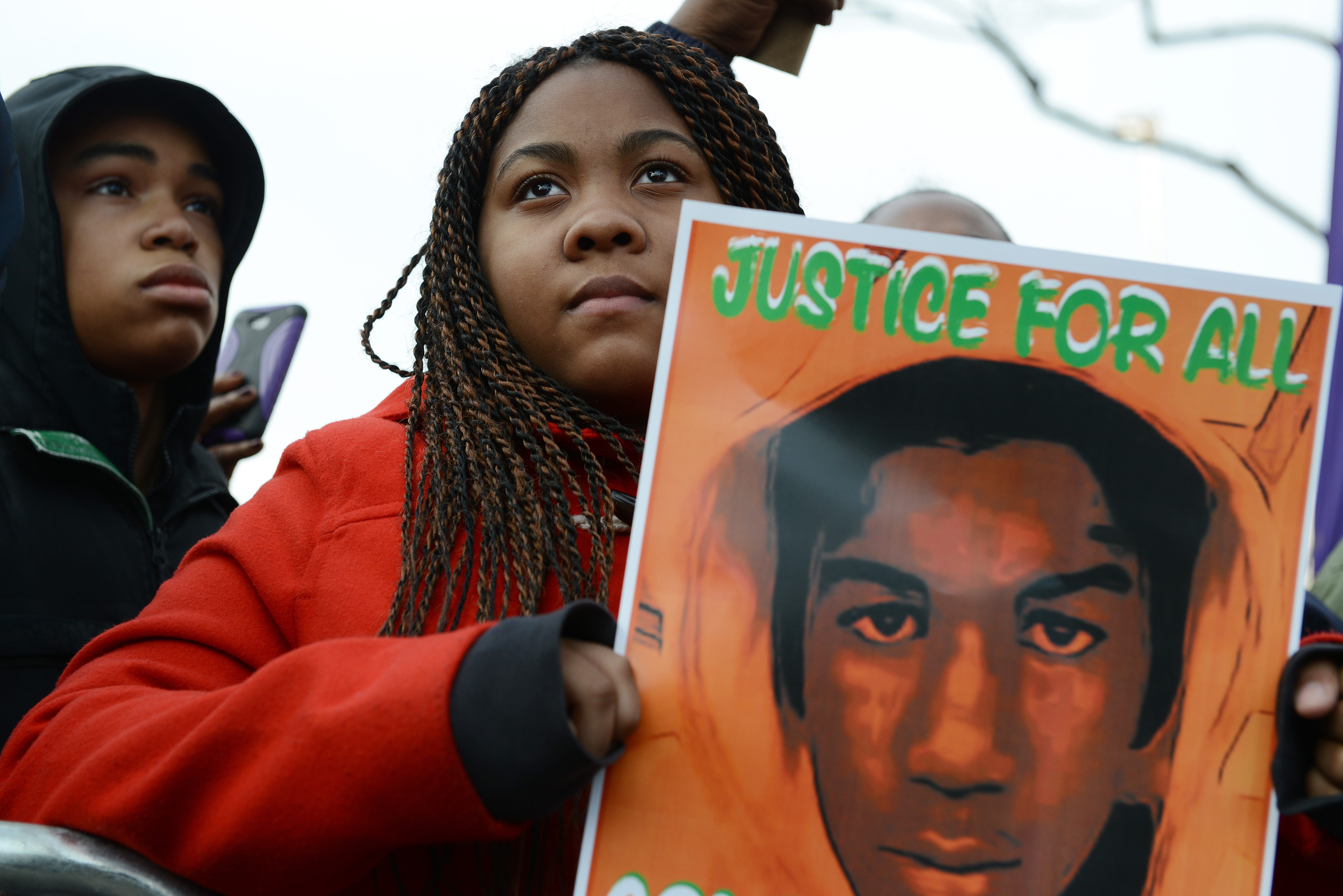 Tatianna Taylor, 14, of Queens, New York holds a Trayvon Martin sign at a rally in Washington, D.C. The slaying of Martin ignited  controversy over Florida's "Stand Your Ground" law, which later became ALEC model legislation.