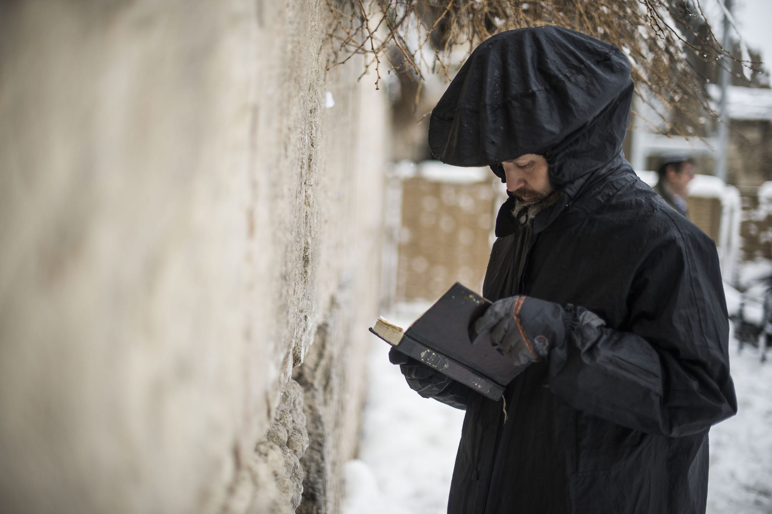 A man reads scripture at the Western Wall.
