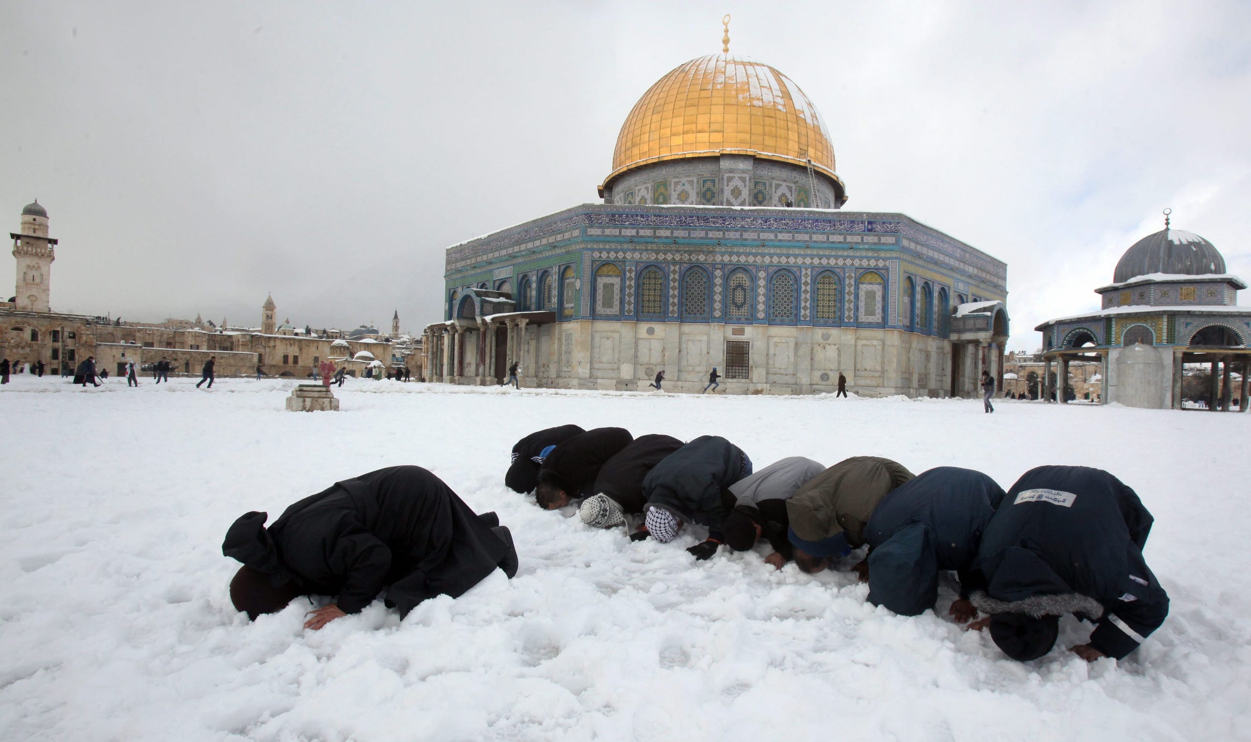 Palestinians pray on the plaza of the Dome of the Rock in Jerusalem following a snow storm on Feb. 20.