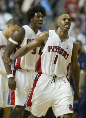 Pistons' Chauncey Billups (1) and Ben Wallace, background, celebrate during the third quarter against the New Jersey Nets in Game 7 of the Eastern Conference semifinals May 20, 2004 at the Palace.
