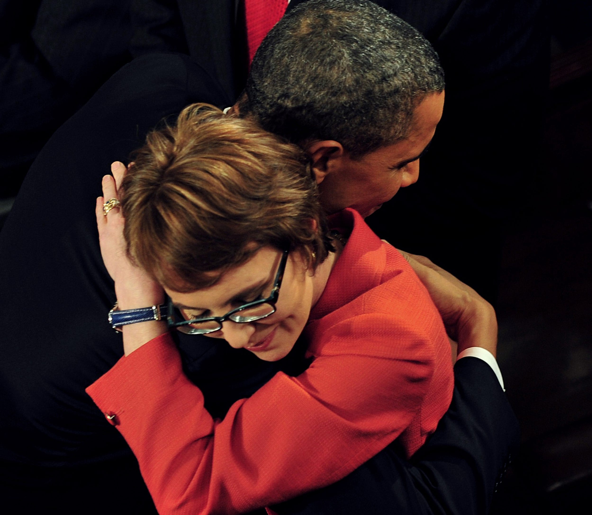 President Barack Obama hugs retiring Congresswoman Gabrielle Giffords as the president arrives to deliver his State of the Union address on Jan. 24, 2012, in Washington, D.C. On Jan. 8, 2011, Giffords was a victim of a shooting near Tucson.