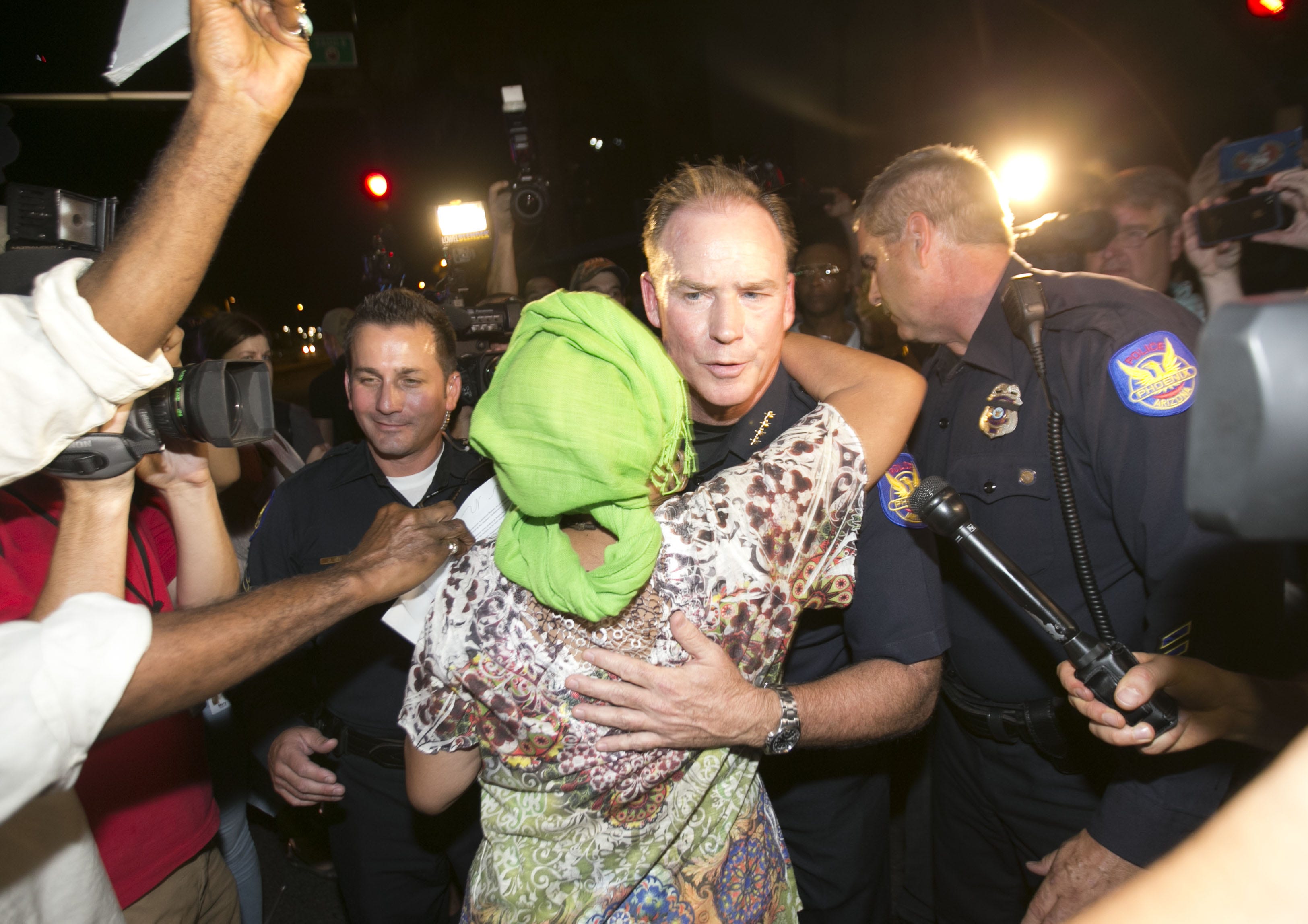 Phoenix Police Chief Joe Yahner hugs Frances Garrett, the mother of Michelle Cusseaux in the middle of 24th Street during a protest July 16, 2016. Cusseaux was killed by Phoenix police in August of 2014.