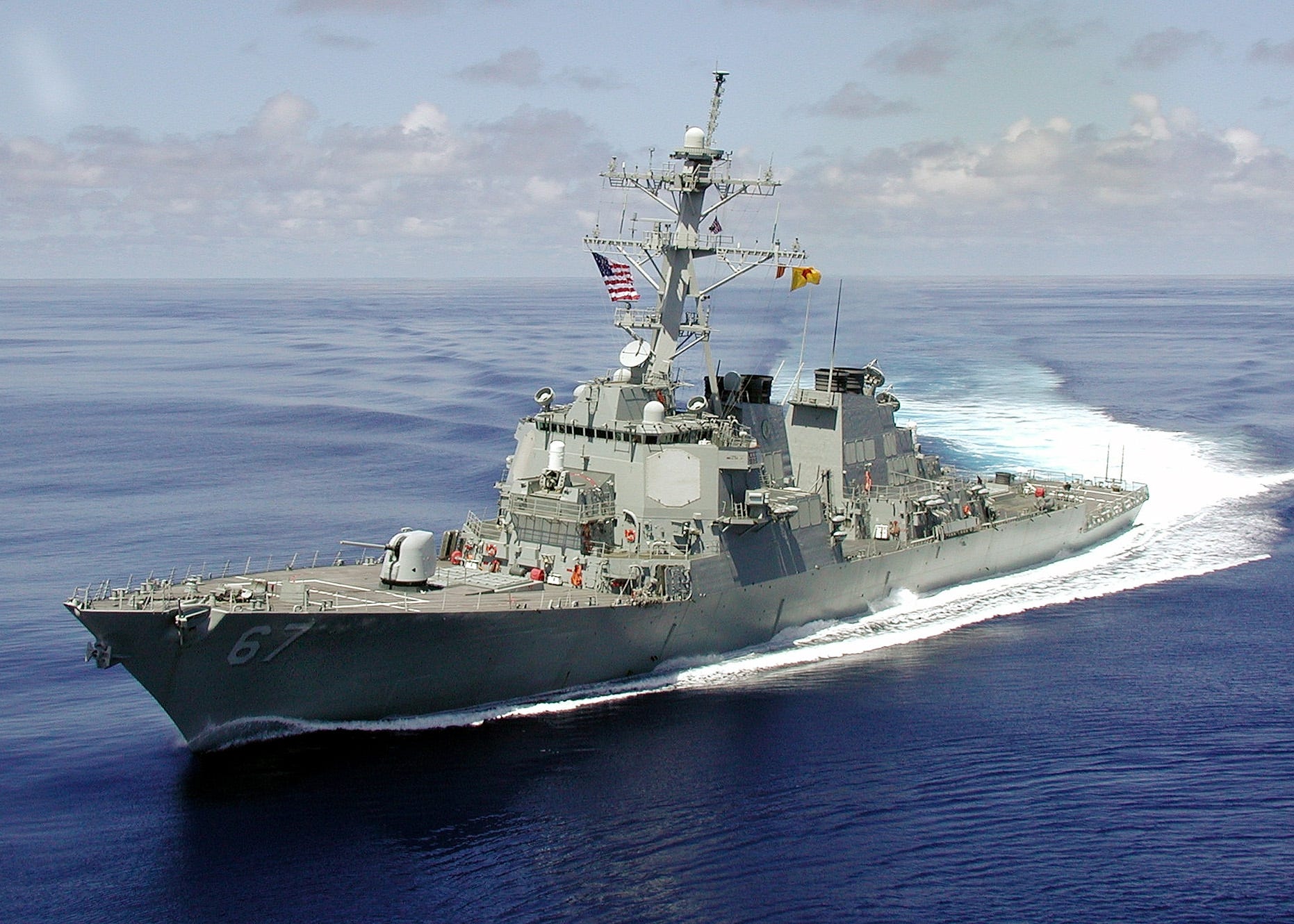 Tthe naval destroyer USS Cole, which is equipped with the Aegis radar array missile defense system developed by Lockheed Martin of Moorestown. The array are the large octagonal shapes on the corners of the lower part of the ship superstructure. Aegis locates and identifies incoming ships, planes or missiles. The ship's defense missiles are located below deck behind the forward gun.