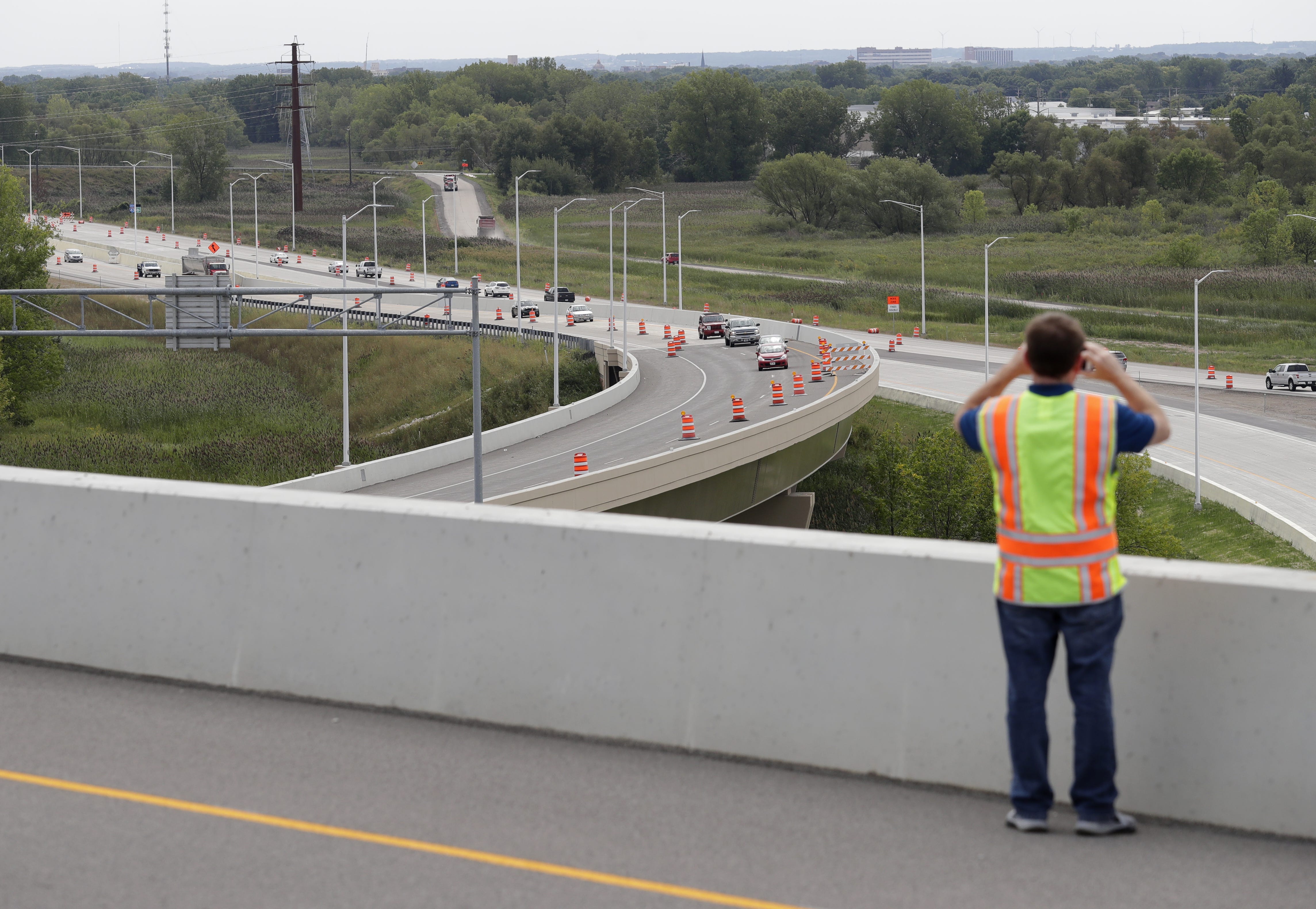 U.S. 41 Project Communication ManagerMark Kantola takes a photo in 2016 from a high viewpoint as traffic moves on northbound Interstate 41 under the recently completed flyover ramp that connects northbound Interstate 43 to southbound I-41.
