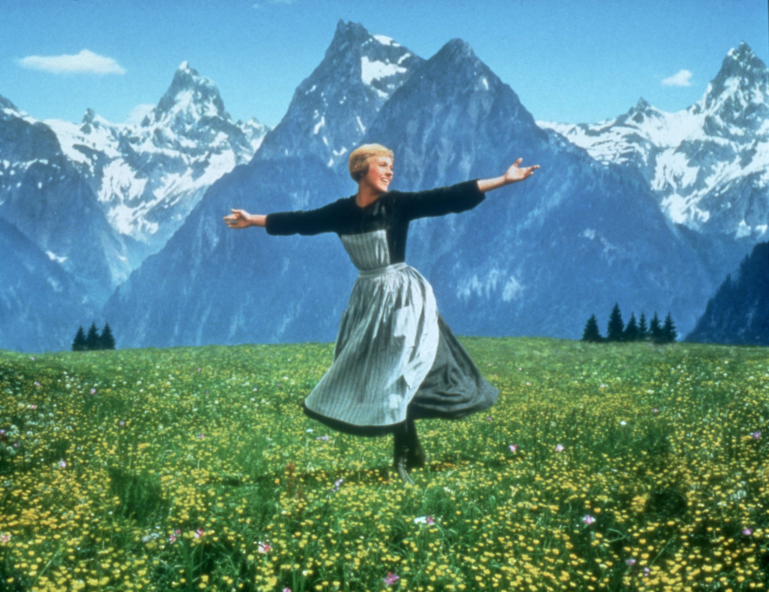 Julie Andrews twirling on a mountain top in the famous opening scene from the 1965 motion picture 'The Sound of Music.'