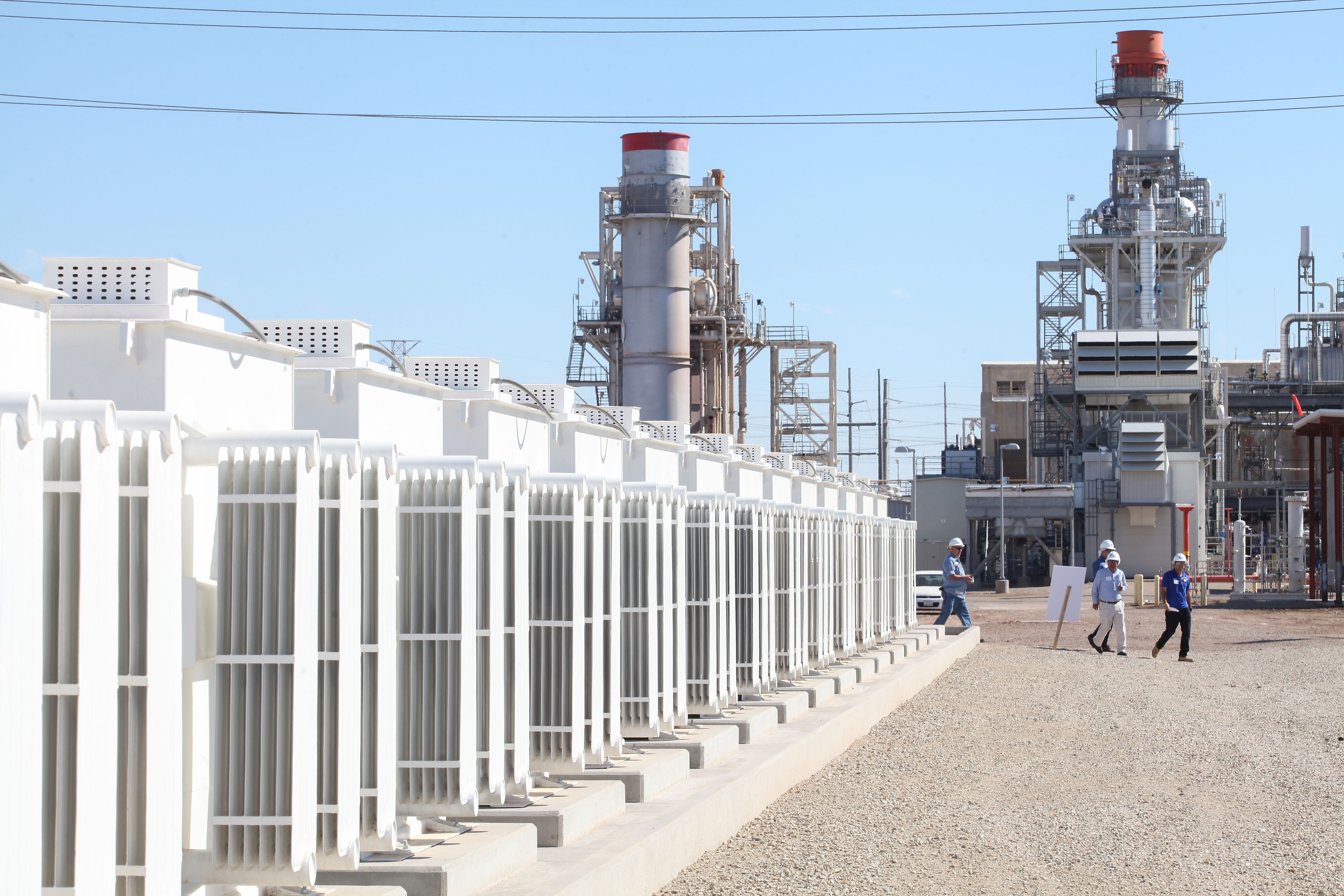 A 140-megawatt natural gas-fired power plants looms over the Imperial Irrigation District's 30-megawatt battery storage facility in El Centro, California on Oct. 26, 2016.