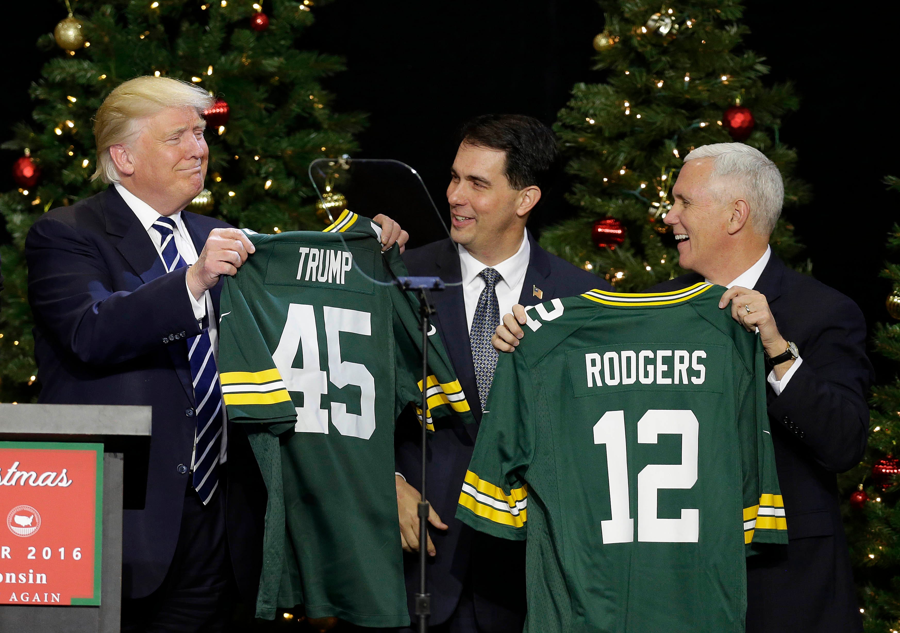 President-Elect Donald J. Trump  and Vice President-Elect Mike Pence, accept Packers jerseys from Governor Scott Walker and House Speaker Paul Ryan after Trump spoke  to supporters at the Wisconsin State Fair Exposition Center as part of the USA Thank You Tour 2016. Trump and Vice-President-Elect Mike Pence are touring states that helped him win the presidency in November.