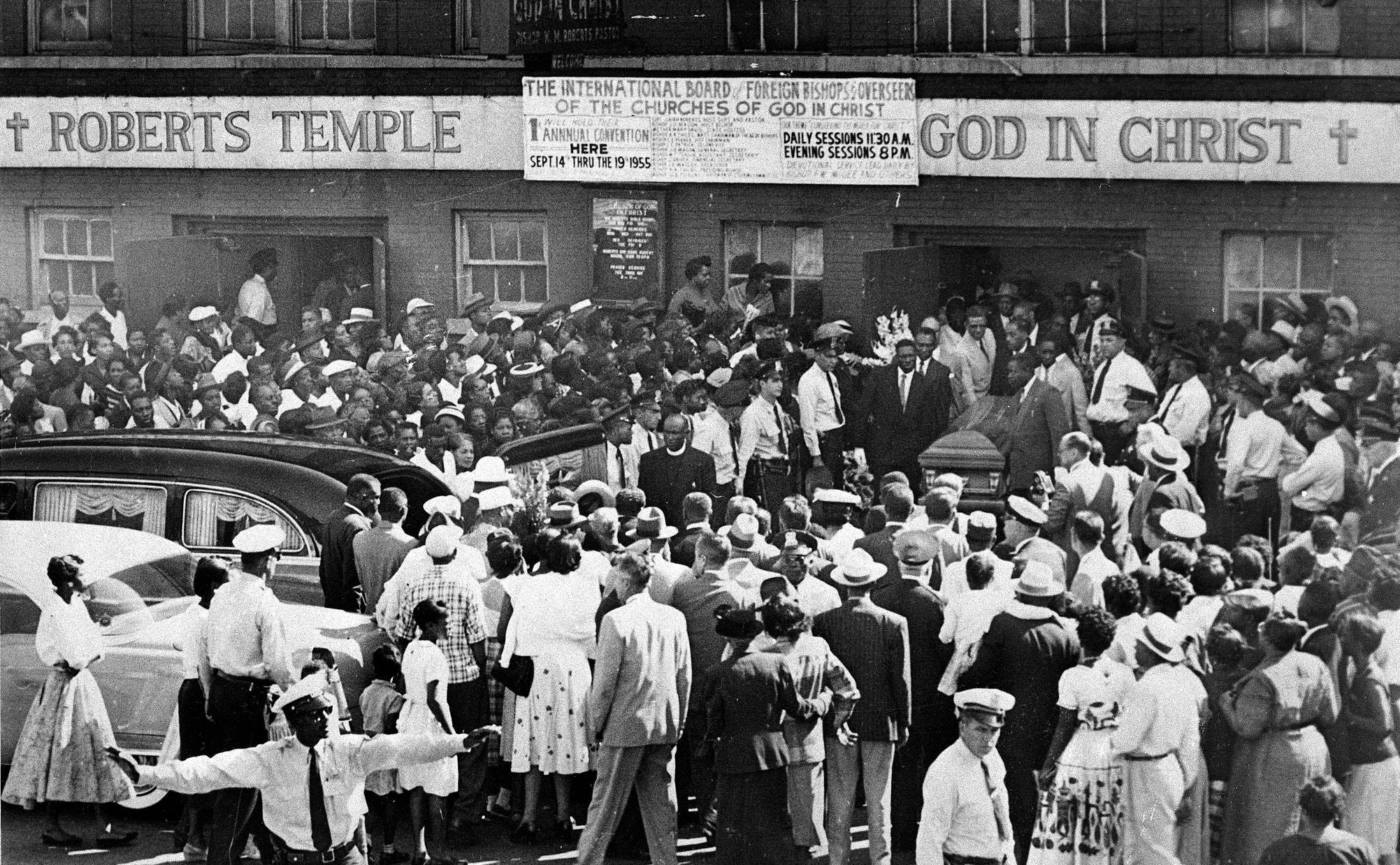 A large crowd gathers outside the Roberts Temple Church of God In Christ in Chicago, Ill., Sept. 6, 1955, as pallbearers carry the casket of 14-year-old Emmett Till who was slain during a visit to Mississippi.