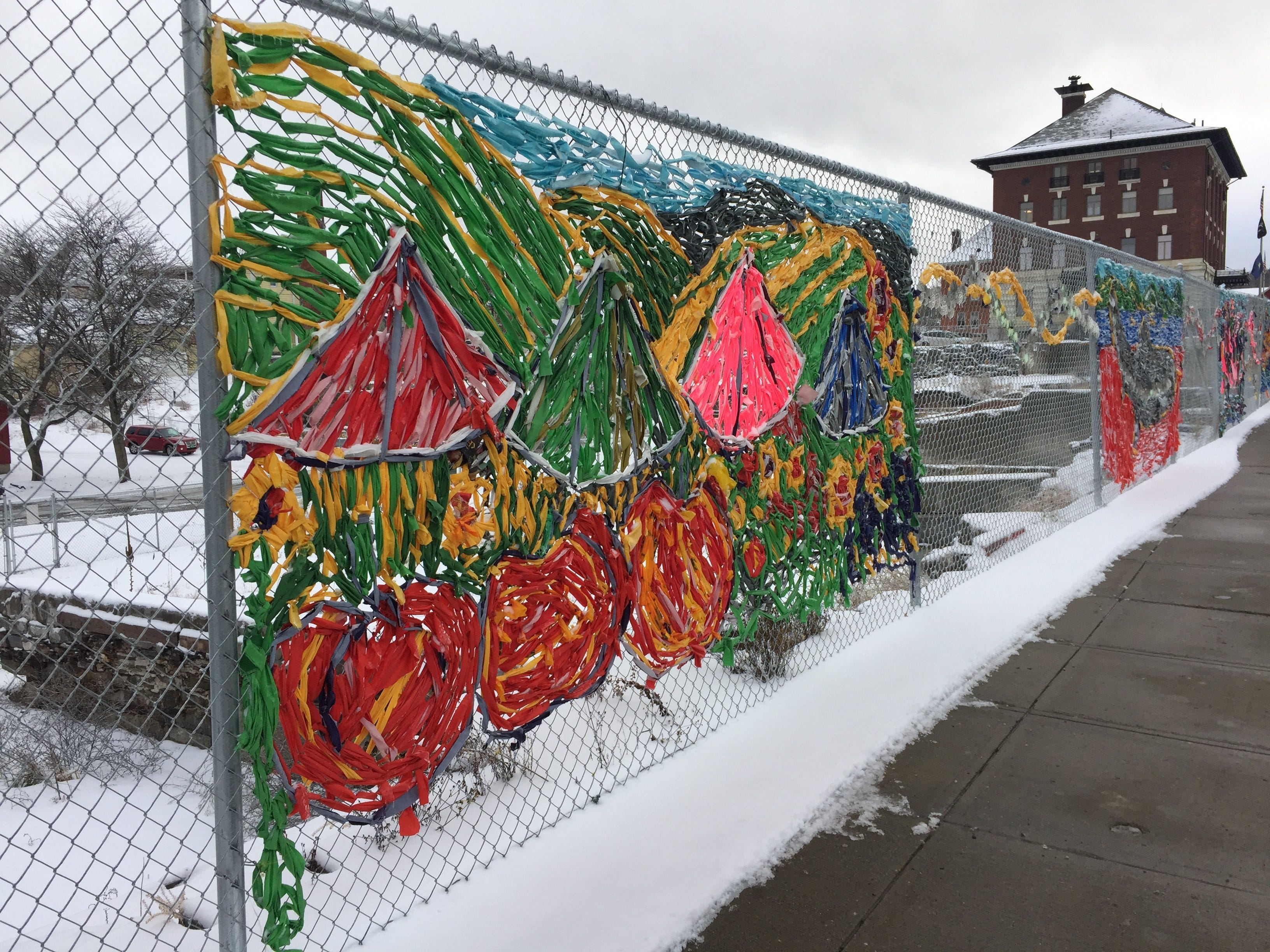 A group of Newport residents took it upon themselves to brighten the fence surrounding a failed EB-5 project downtown.