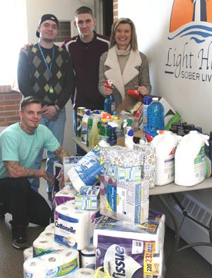 Simple Gestures recently donated to Light House Sober Living. Kathy Jo Schweitzer, right, organizer of Simple Gestures, presented Director Kenn Bower and two house residents, with a total of  625 products.
