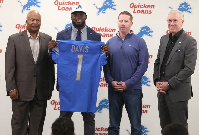 (From left) Lions coach Jim Caldwell, first-round draft pick Jarrad Davis, general manager Bob Quinn and president Rod Wood at the Allen Park practice facility Friday, April 28, 2017.
