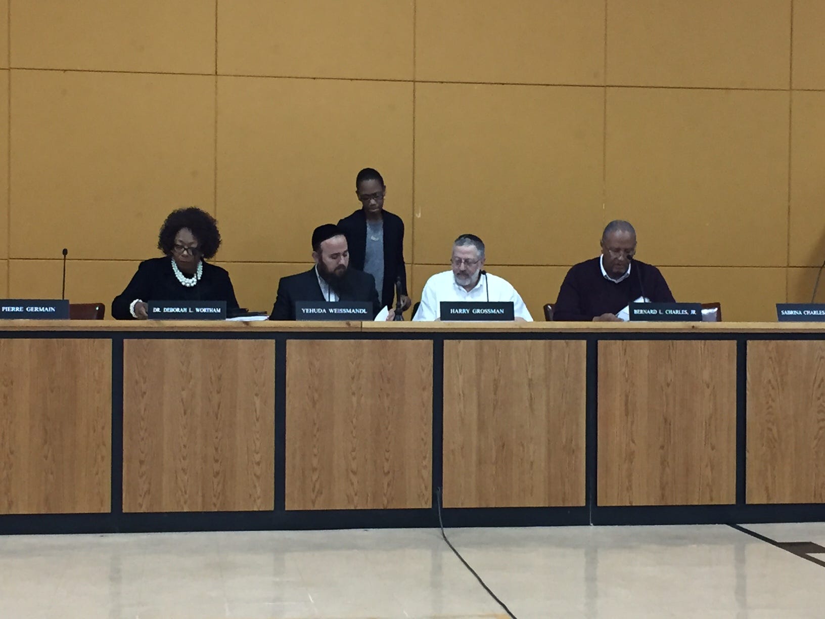 From left: East Ramapo Superintendent Deborah Wortham, School Board President Yehuda Weissmandl, board member Sabrina Charles-Pierre (standing), board member Harry Grossman and board member Bernard Charles prior to the April 26, 2017, special meeting.