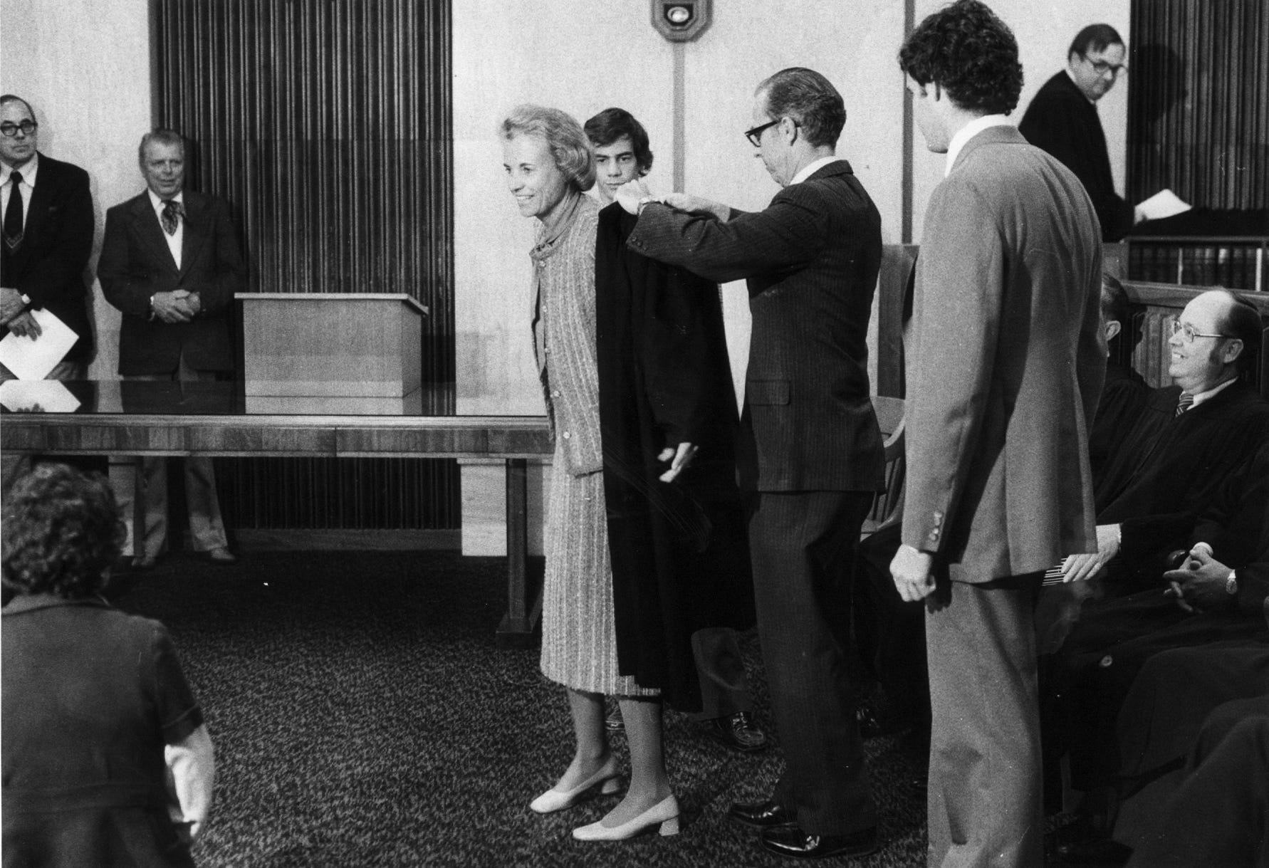 New Court of Appeals Judge Sandra Day O'Connor is helped into her robe by her husband, John, after swearing-in ceremonies at the Arizona Supreme Court on Dec. 4, 1979. O'Connor was a Maricopa County Superior Court judge until being appointed to the state bench by Gov. Bruce Babbitt.