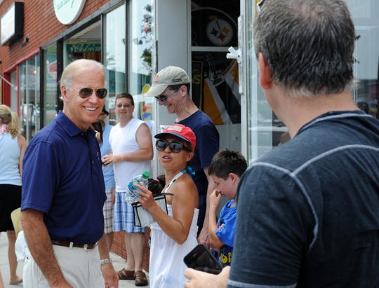 Vice President Joe Biden greets the people of Rehoboth Avenue in Rehoboth Beach in 2012 while his wife Jill signs copies of her book at Browseabout Books.  The Bidens, who frequent Rehoboth Beach, recently bought a vacation retreat in Cape Henlopen State Park.