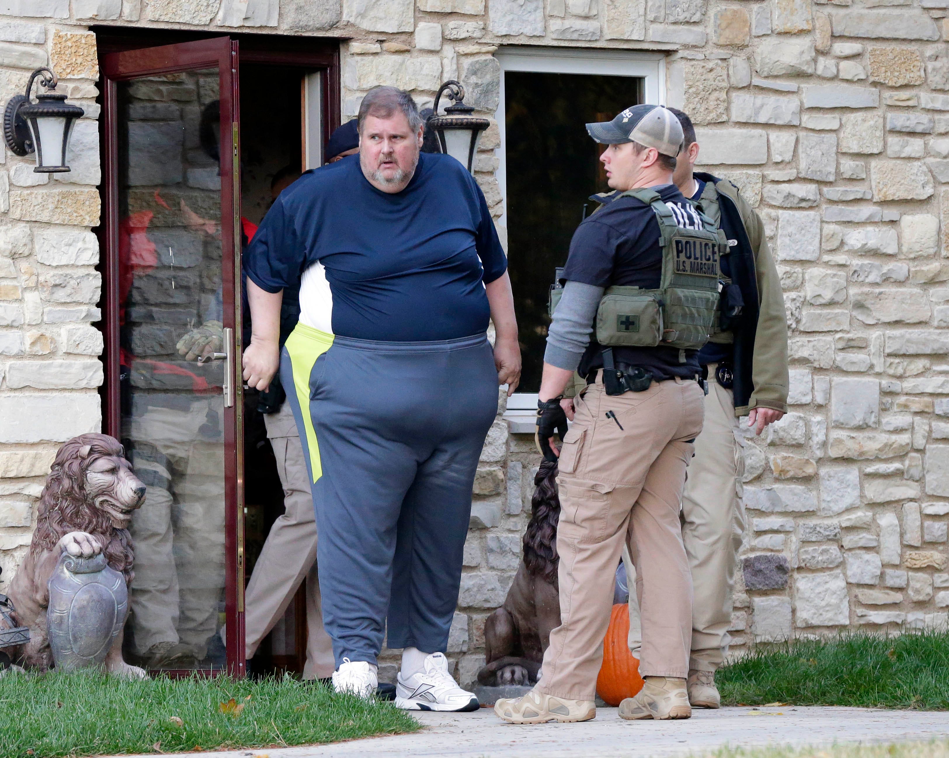 Todd Brunner is seen exiting his home after being arrested in 2014.