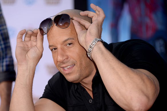 Shaved head, check... Shades, check... Big biceps, check! Vin Diesel attends the Hollywood premiere of "Guardians Of The Galaxy" in 2014.