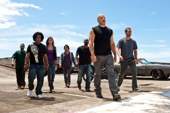 Don Omar, Tego Calderon, Gal Gadot, Sung Kang, Tyrese Gibson, Vin Diesel, and Paul Walker in a scene from the 2011 thriller "Fast Five."