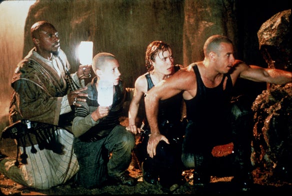 Vin Diesel joins Keith David, Rhiana Griffith, and Radha Mitchell in working together to escape a planet filled with predatory alien creatures in the 2000 film "Pitch Black."