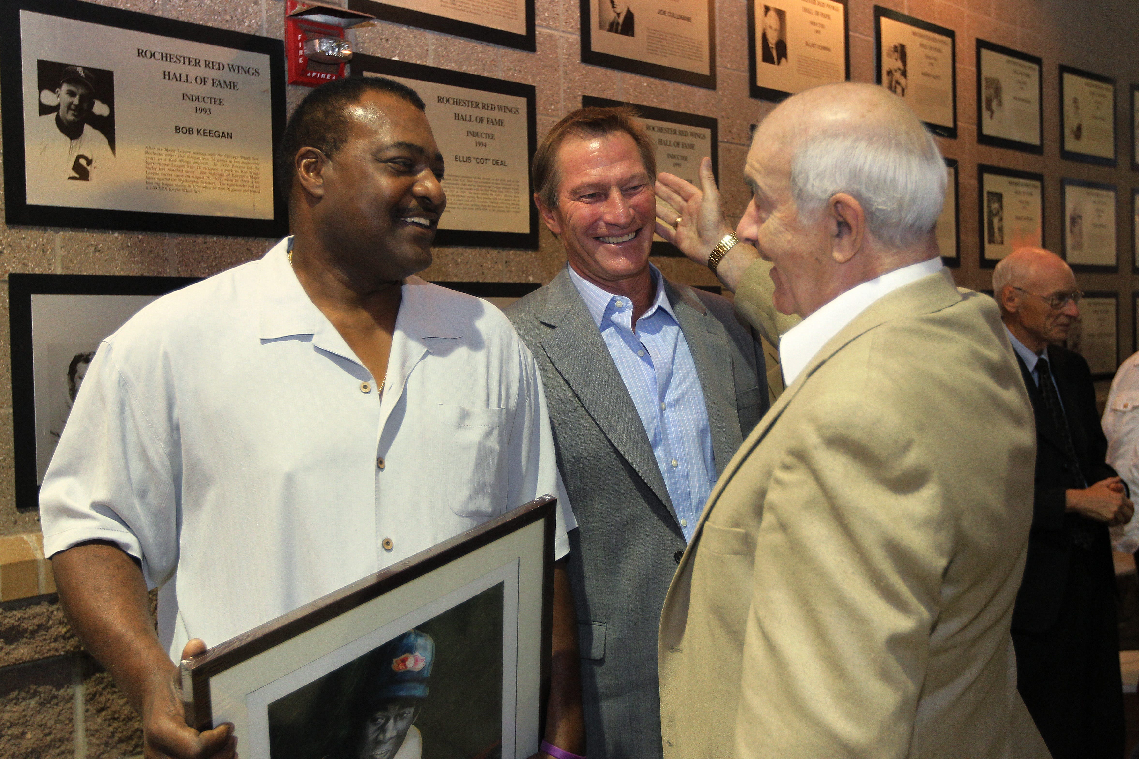 Former Red Wing greats Don Baylor and Bobby Grich are congratulated by their former manager and Rochester baseball legend Joe Altobelli after Grich and Baylor were inducted into the International League Hall of Fame.