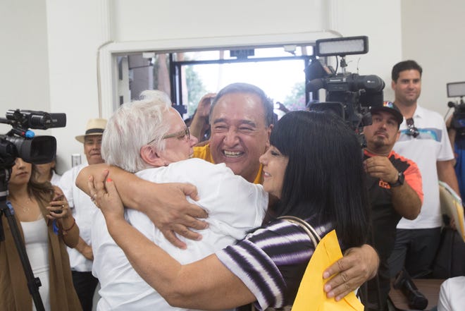 At center, Mario Lazcano, immigrant rights activist, is embraced by fellow activists after the Coachella City Council votes to declare the city a sanctuary city.