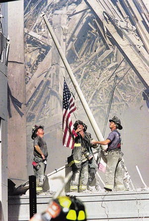 Part of a sequence of photos of three NYC firemen raising a flag at Ground Zero taken on 9/11 of the terrorist attacks that brought down the World Trade Center Twin Towers.