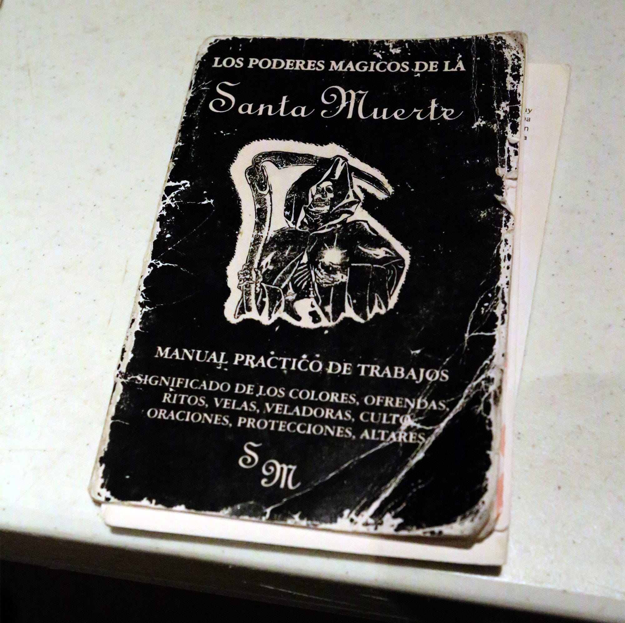 A book written on the “Magical Powers of Santa Muerte” on display during a seminar in El Paso. Police learn to look for clues for search cause — like images of the patron saint of drug traffickers.