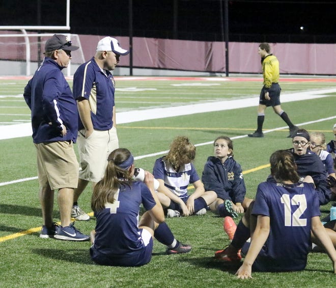 Notre Dame co-head coaches Steve Weber, left, and Kevin Weber talk to their players during a 1-0 loss at Waverly on Sept. 13.