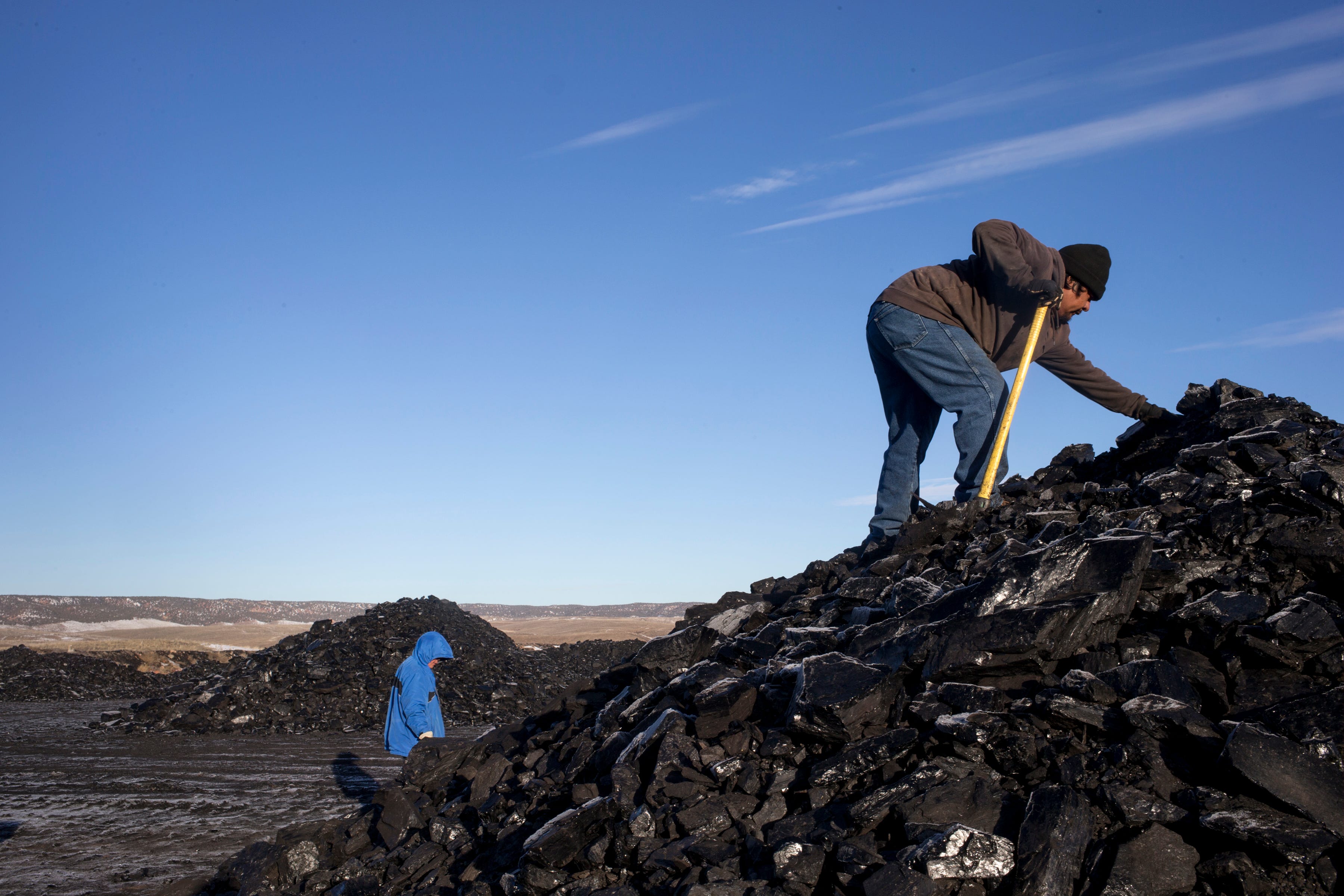 Darryl Sahmea (right) and Dertram Ami gather coal in 2017 at the Kayenta Mine, Arizona.