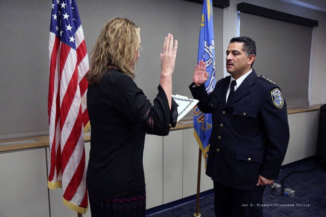 MaryNell Regan, Fire and Police Commission executive director, swears in Alfonso Morales as Milwaukee's interim police chief.