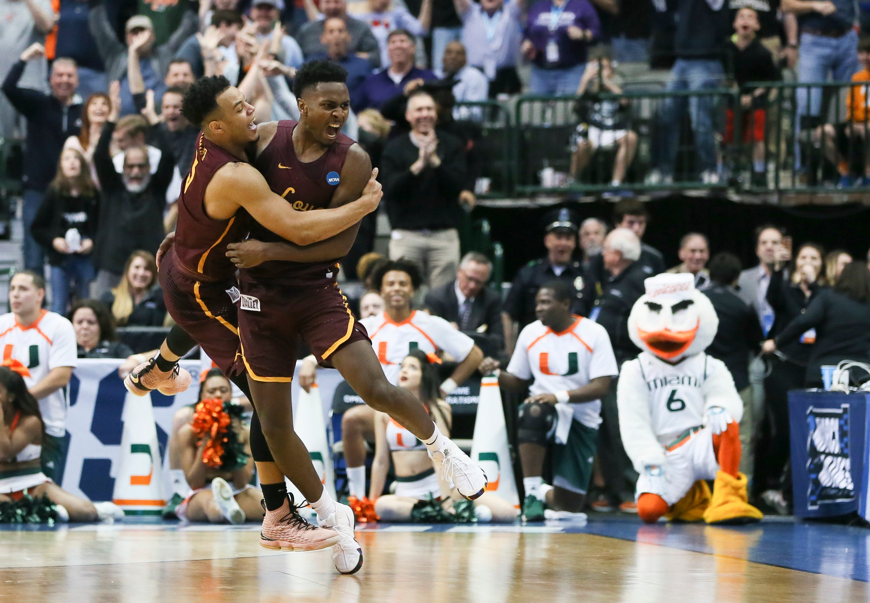 Loyola Ramblers Marques Townes, left, and Donte Ingram, both guards, celebrate during the second half against the Miami  Hurricanes in the first round of the 2018 NCAA Tournament at American Airlines Center in Dallas.