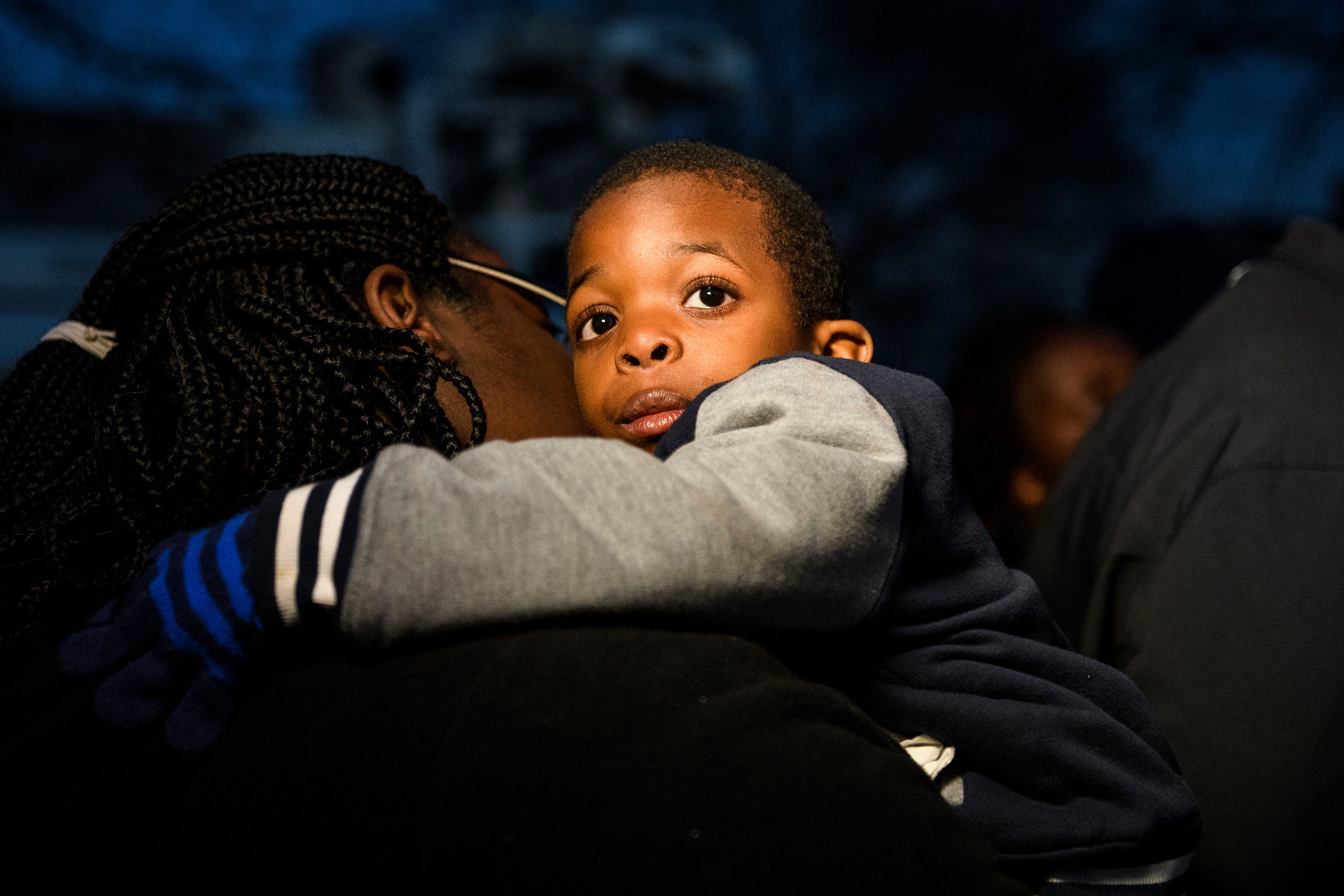 Jermier Massey, 6, is held by his mother, Tiffany Copeland, during a vigil for his father Jermaine Massey near Poe Mill on Wednesday, March 21, 2018.