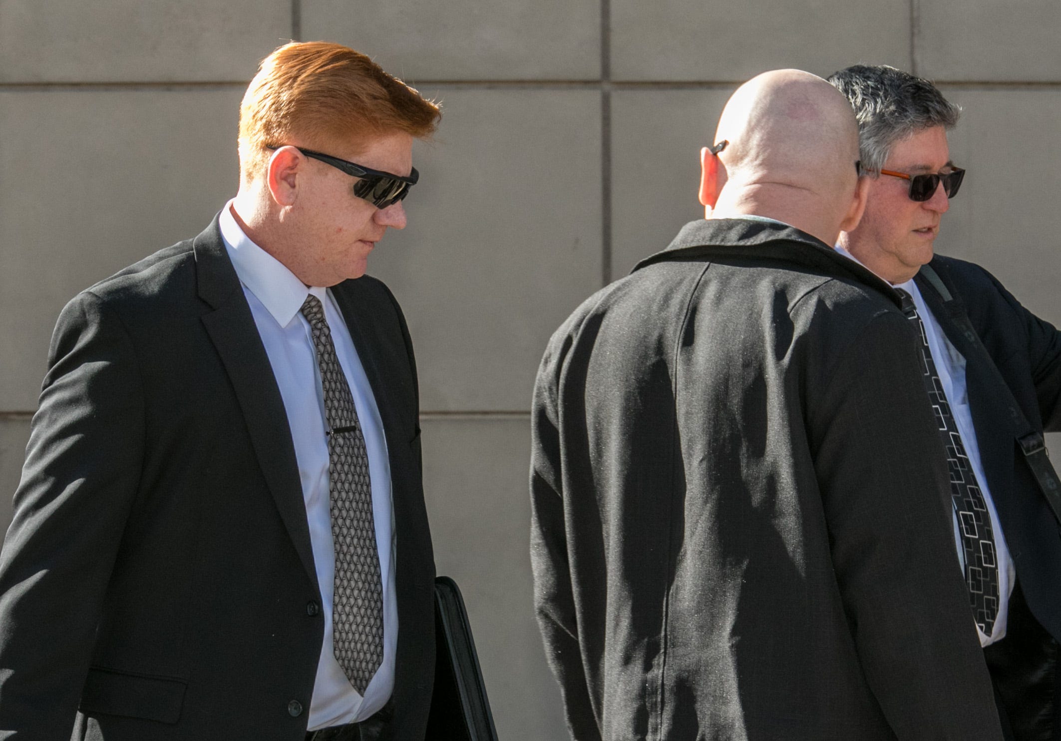 Border Patrol Agent Lonnie Swartz (left) makes his way to the U.S. District Court building in downtown Tucson where opening arguments are scheduled to begin in his murder trial on March 22, 2018.