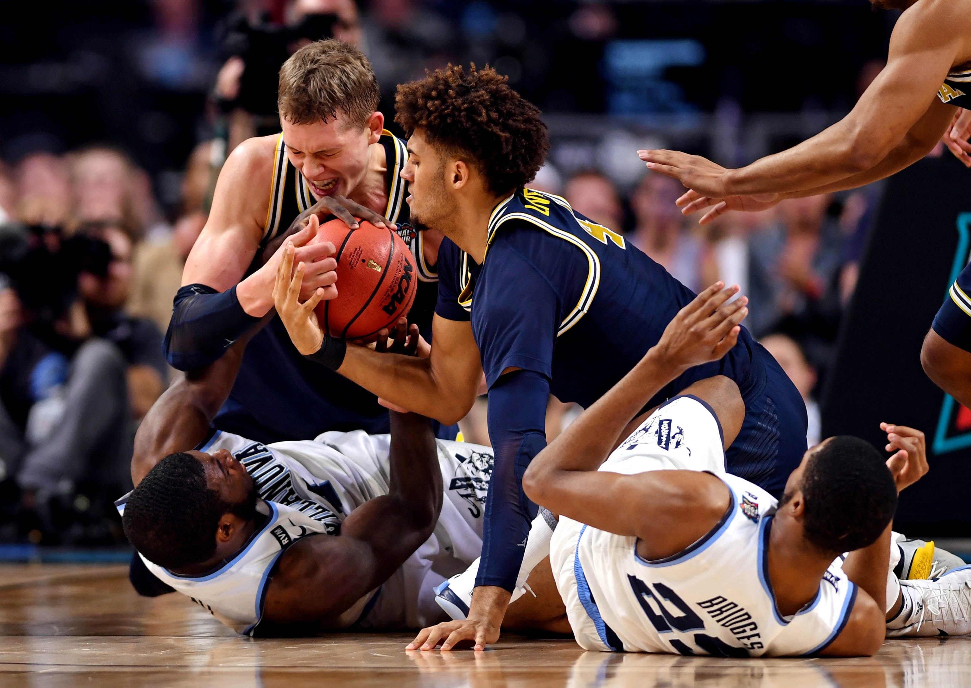 Michigan Wolverines forward Moritz Wagner  and Villanova Wildcats forward Eric Paschall go for the ball during the first half in the championship game of the 2018 men's Final Four at Alamodome in San Antonio.