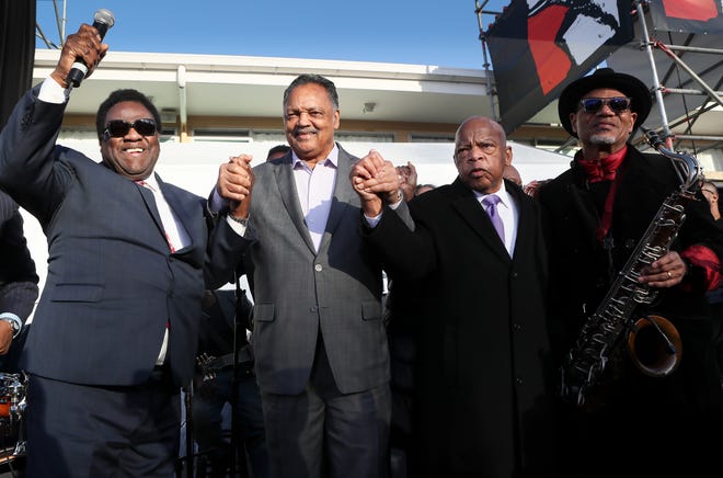 Al Green, Rev. Jesse Jackson, Rep. John Lewis and saxophonist Kirk Whalum wave to the crowd after Al Green's rendition of "Let's Stay Together " at Lorraine Motel and National Civil Rights Museum during the commemoration ceremony for the 50th Anniversary of Martin Luther King Jr.'s assassination Wednesday, April 4, 2018, in Memphis, Tenn.