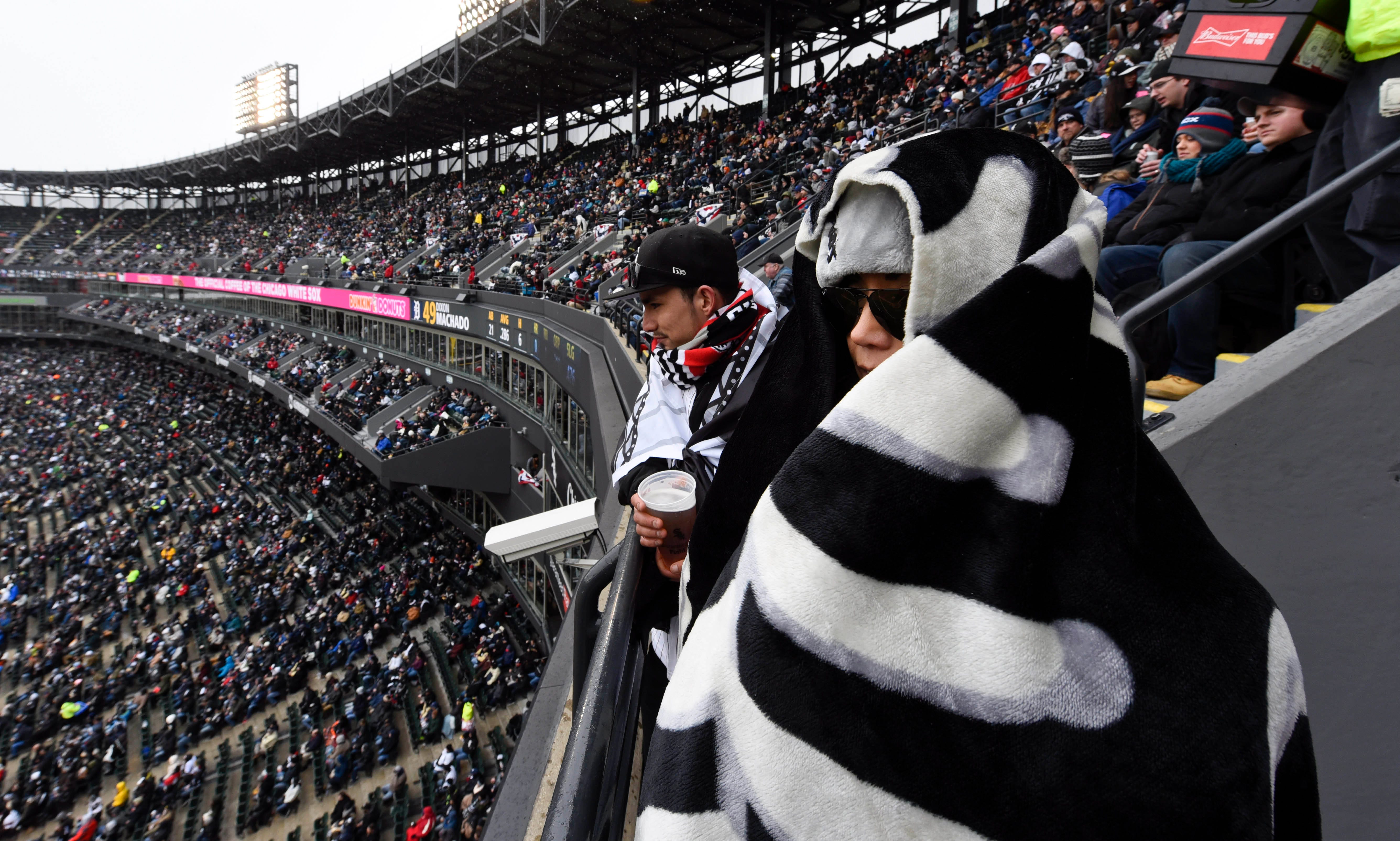 Fans wrapped in blankets at Guaranteed Rate Field for the opening game between the Chicago White Sox and the Detroit Tigers in Chicago.