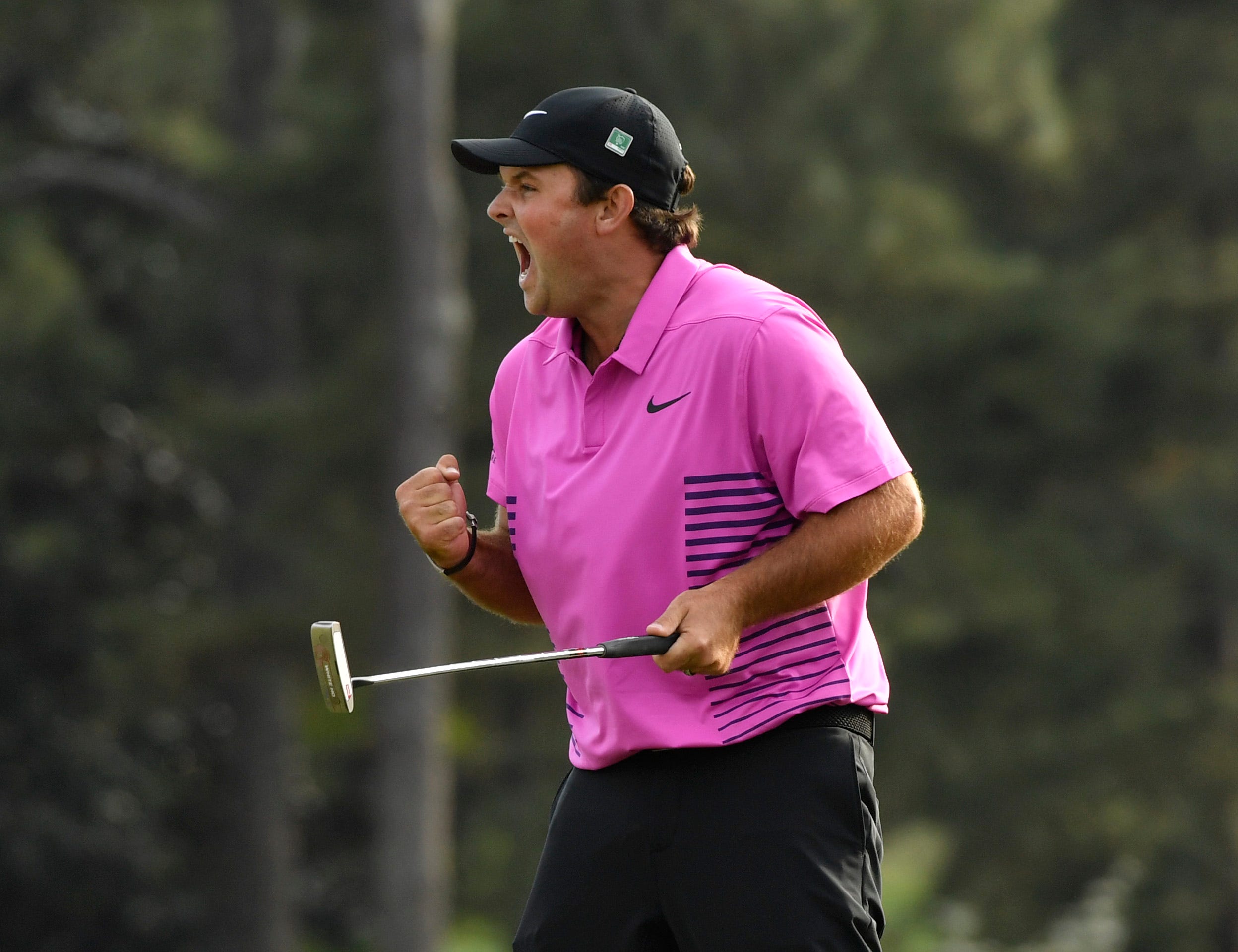 Patrick Reed celebrates after making a putt on the 18th green to win the Masters golf tournament at Augusta National Golf Club in Augusta, Ga.