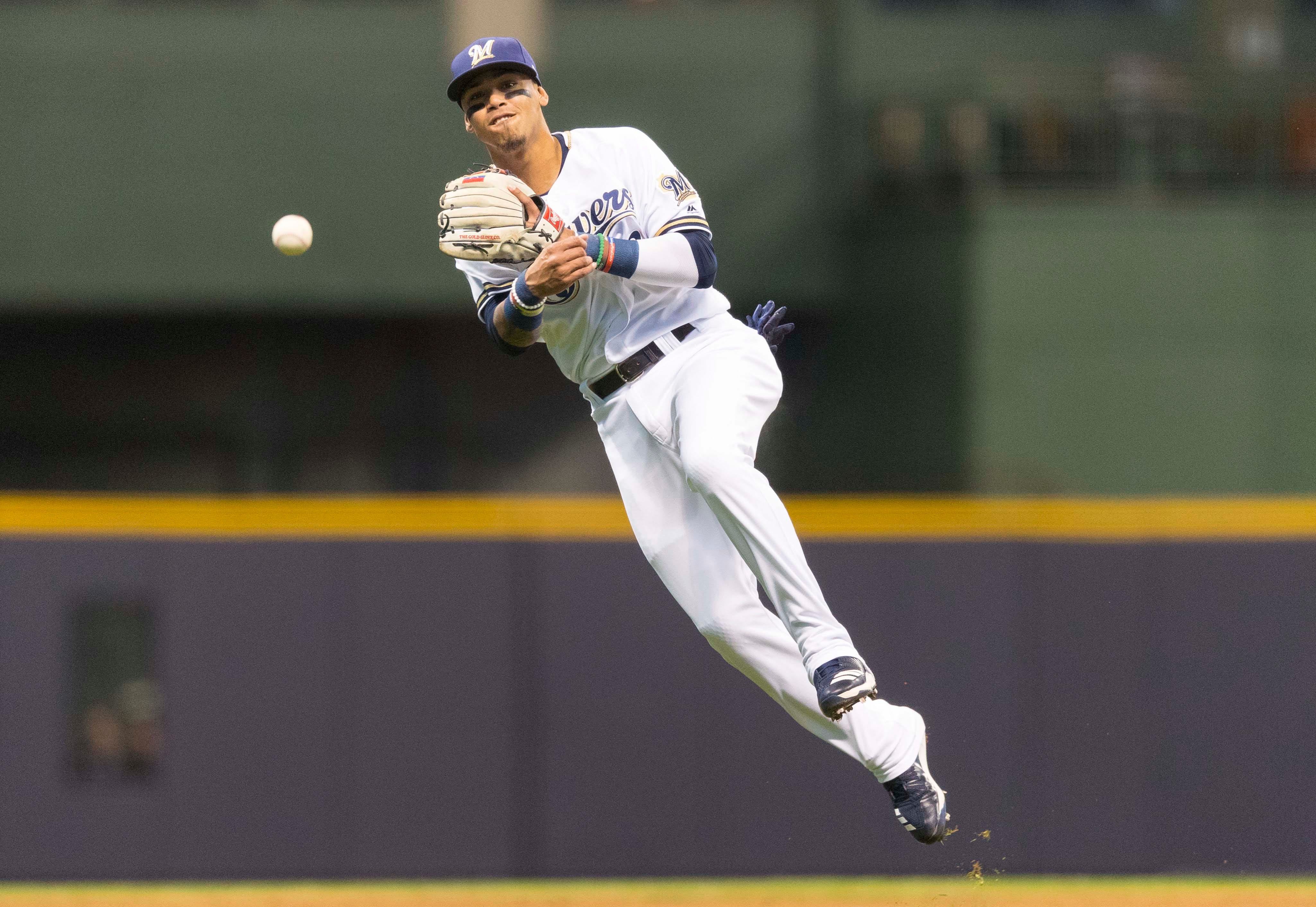 Milwaukee Brewers shortstop Orlando Arcia throws out Cincinnati Reds right fielder Jesse Winker during the third inning at Miller Park in Milwaukee.