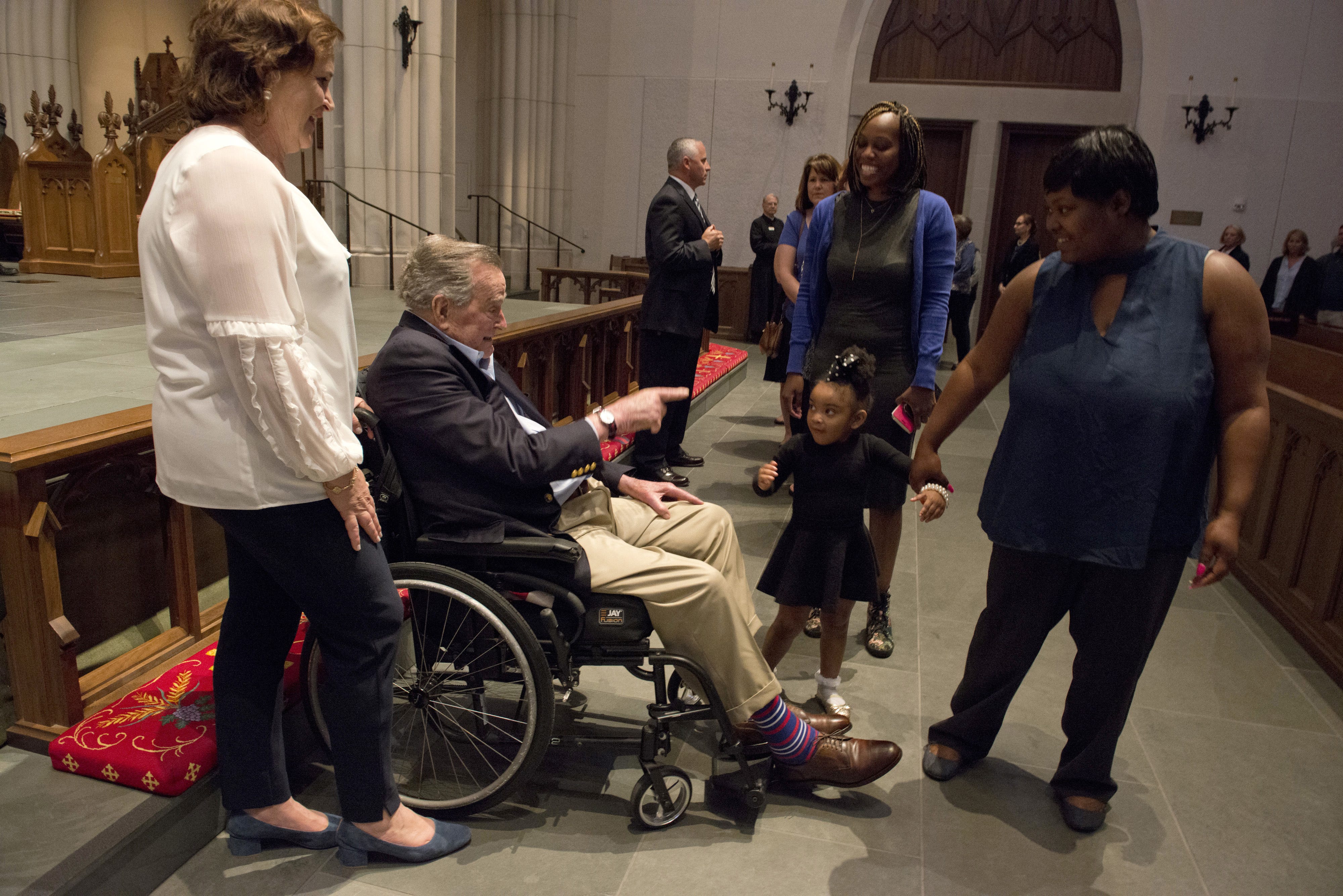 George H.W. Bush greets people paying respects to Barbara Bush