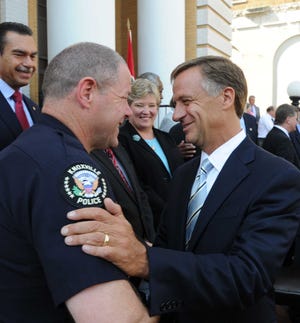Gov. Bill Haslam, right, greets Knoxville Police Chief David Rausch after signing the anti-methamphetamine bill into law Monday, Jun. 6, 2011 at the Greene County Courthouse.