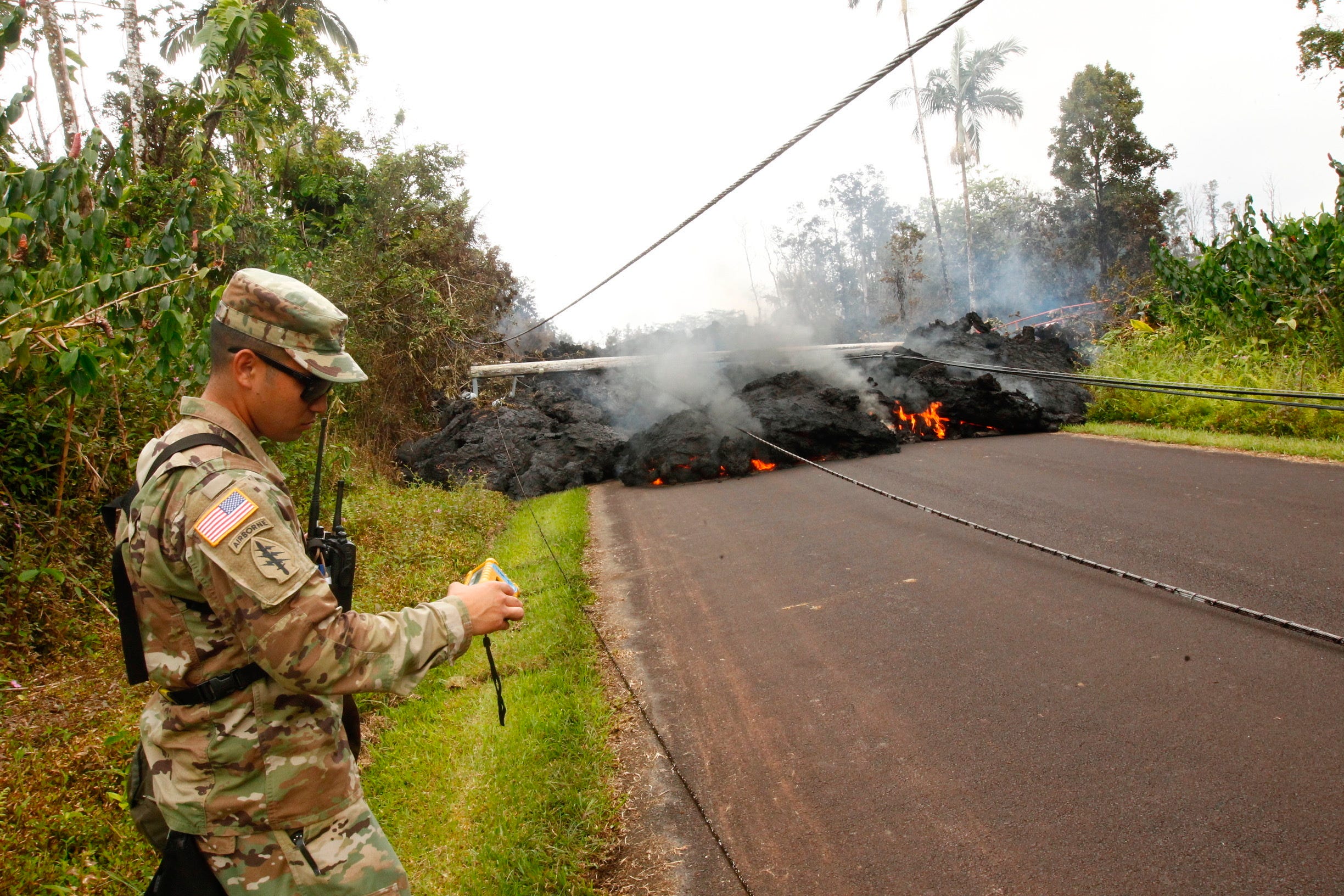 Lava continues to overrun Hookupu Street, May 7, 2018, in Pahoa, Hawaii. Hawaii's Kilauea volcano has destroyed homes and spewed lava hundreds of feet into the air, leaving evacuated residents unsure how long they might be displaced.