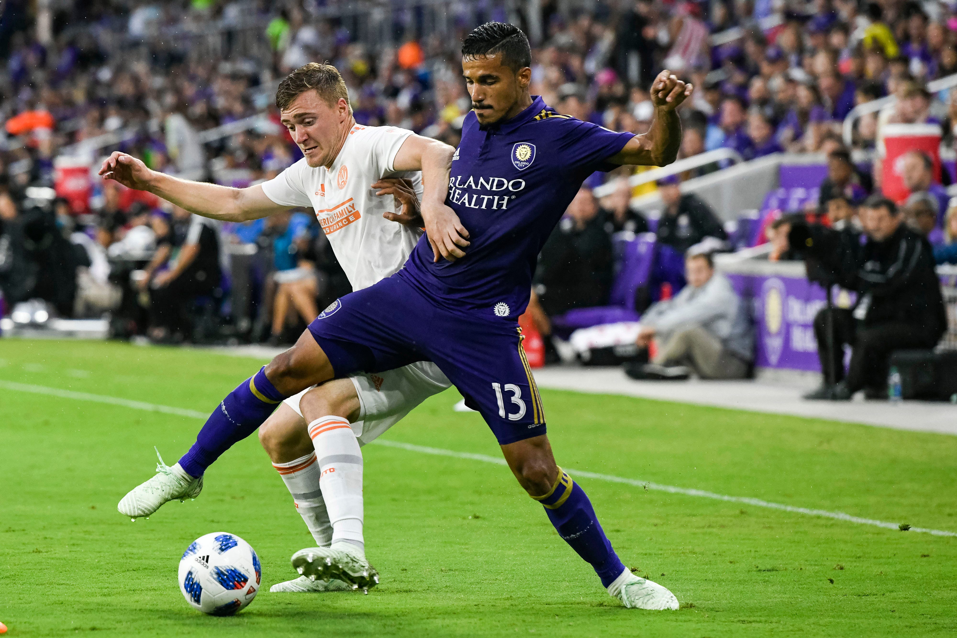 Mohamed El-Munir, right, of Orlando City SC, fights for the ball with Atlanta United midfielder Julian Gressel during the second half of the game at Orlando City Stadium.