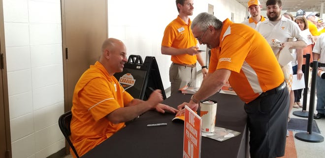 Tennessee coach Jeremy Pruitt signs autographs during UT's Big Orange Caravan in Memphis on May 15, 2018.