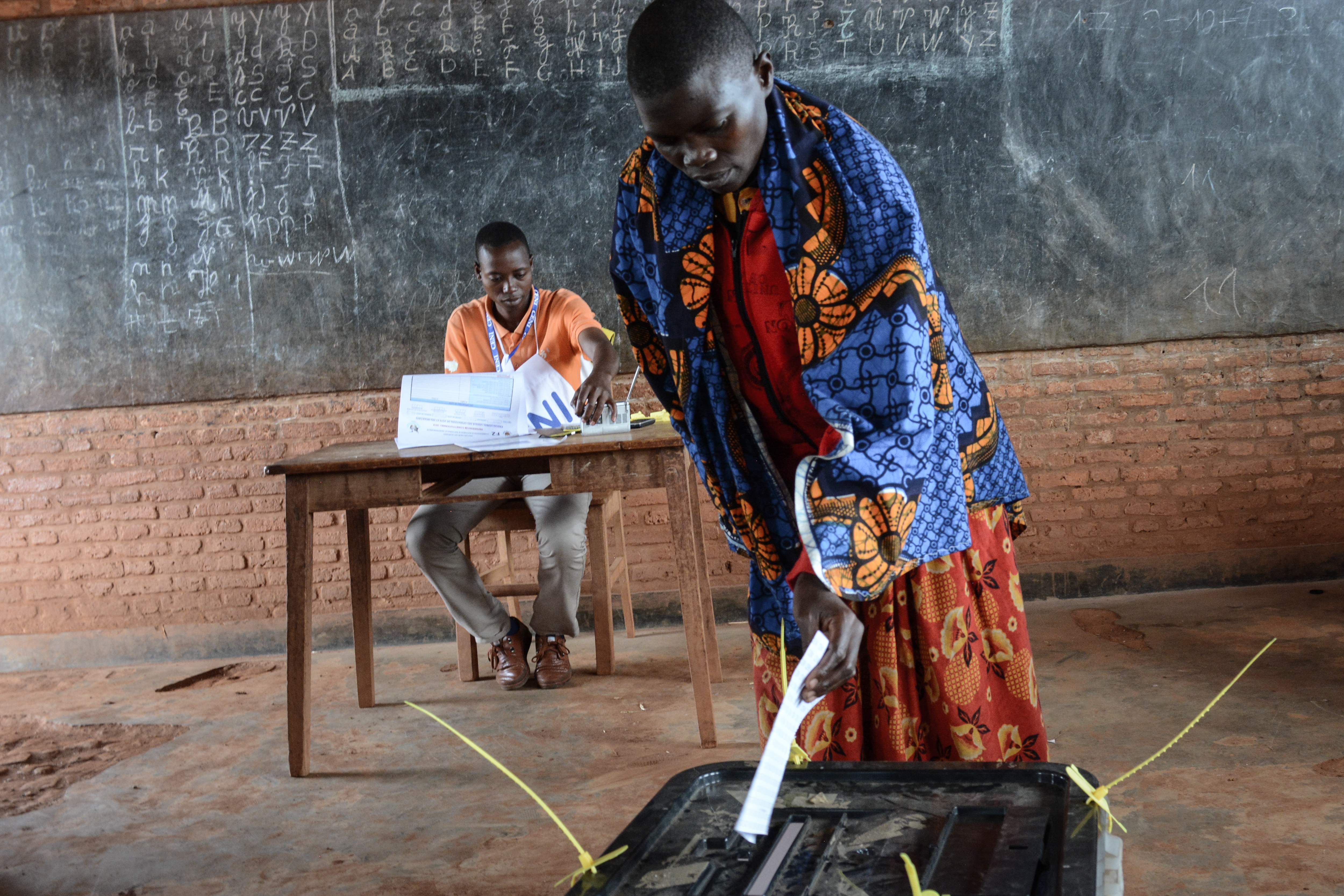 A woman casts her vote at a polling station in Ciri, Burundi, on May 17, 2018 during a referendum on constitutional reforms that, if passed, will shore up the power of the incumbent President and enable him to rule until 2034.  For many critics, the r