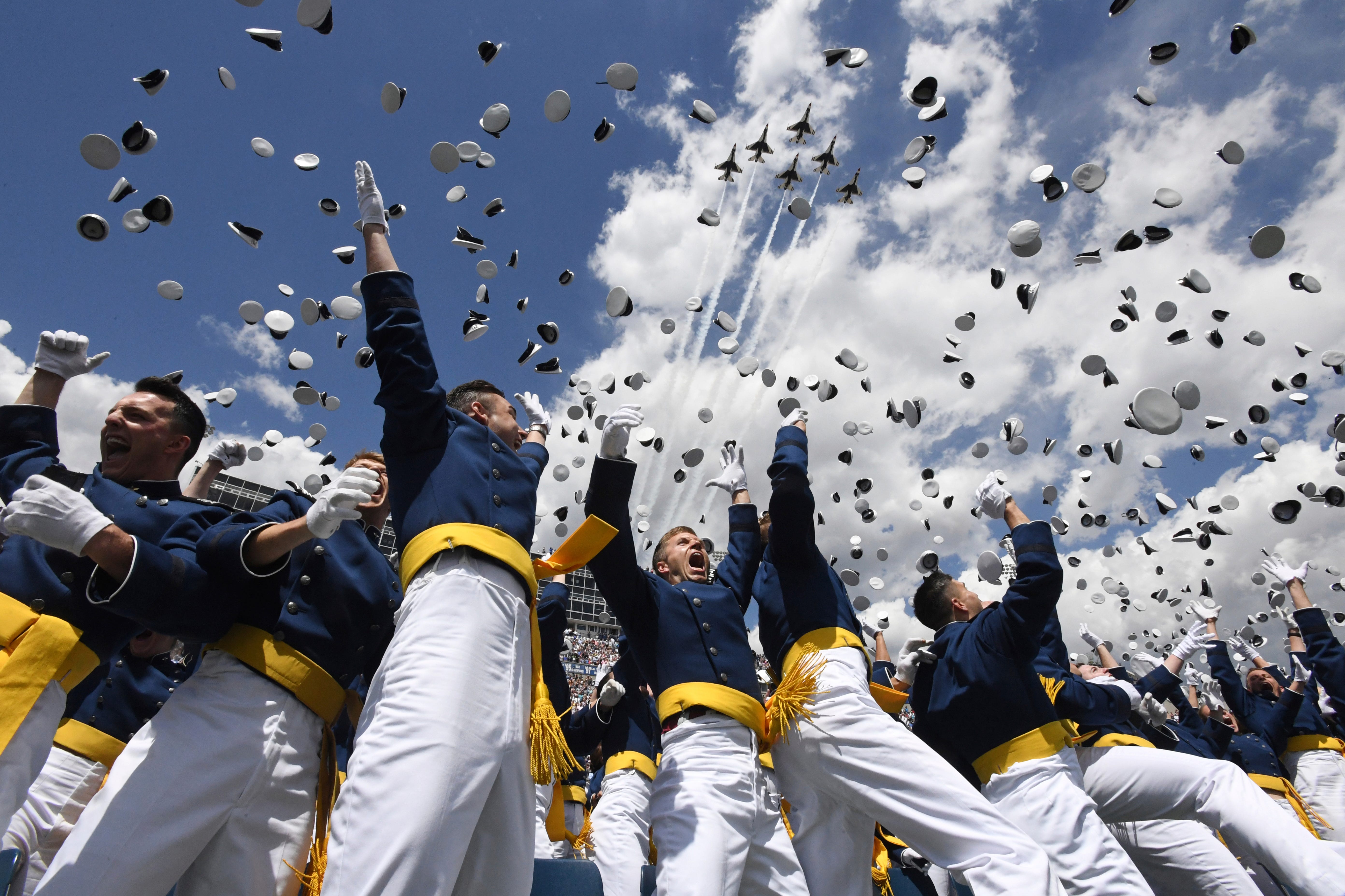 U.S. Air Force Academy cadets toss their hats in the air as the Thunderbirds fly overhead during the cadets' graduation ceremony in Colorado Springs, Colo.