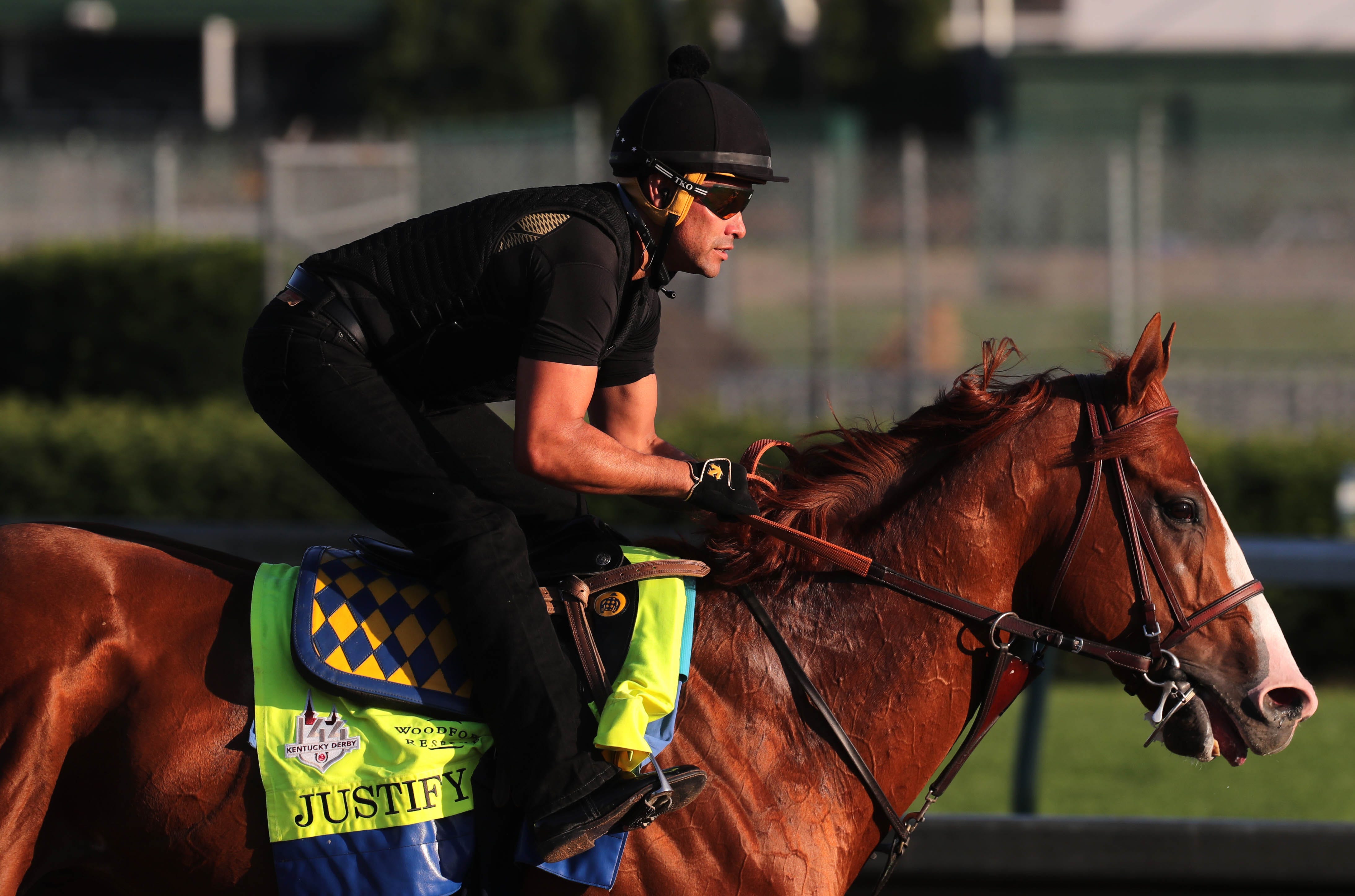 Exercise rider Humberto Gomez takes Justify out for a light gallop at Churchill Downs in Louisville, Ky.