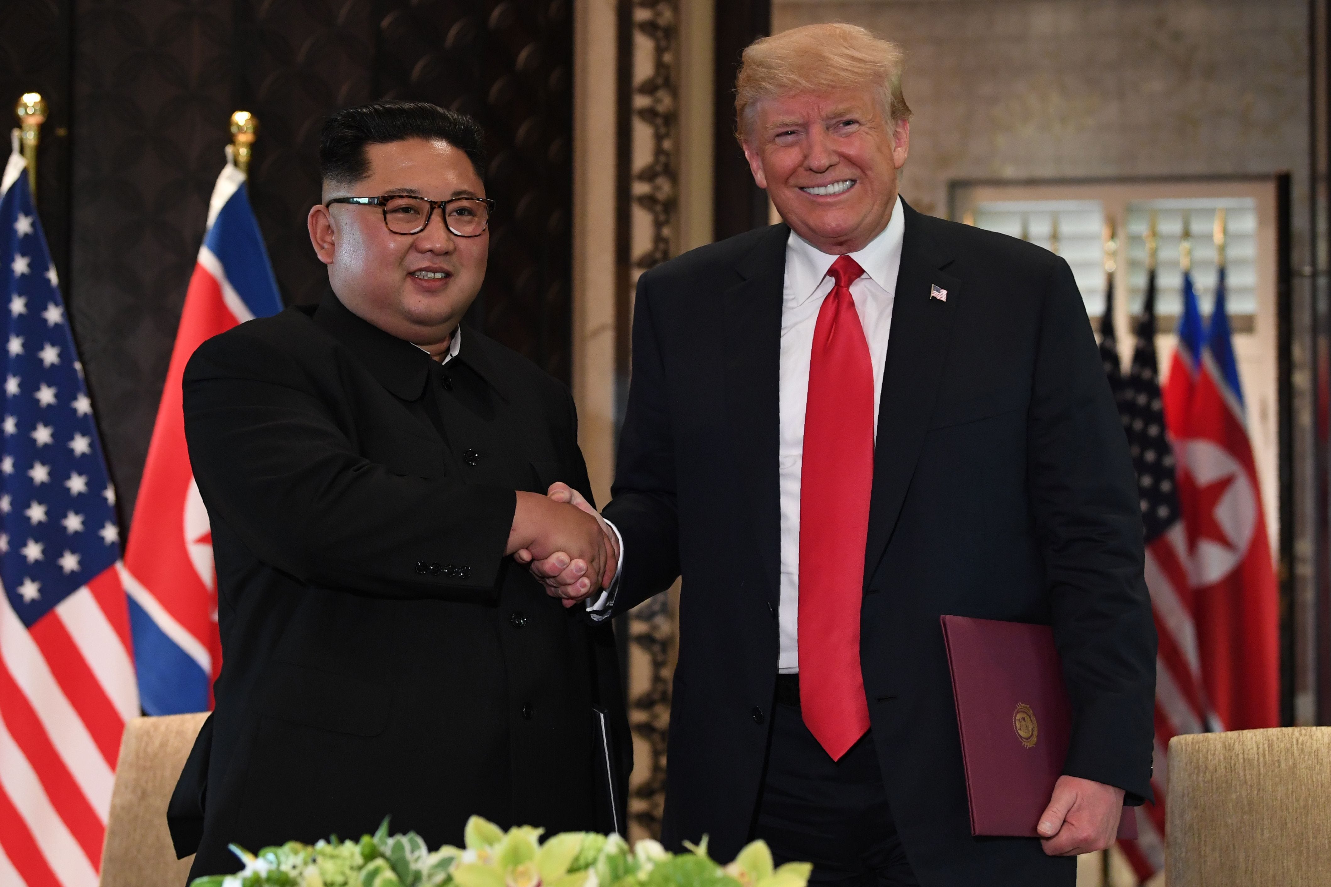 President Trump and North Korea's leader Kim Jong Un shake hands following a signing ceremony during their historic US-North Korea summit, at the Capella Hotel on Sentosa island in Singapore on June 12, 2018.  Trump and North Korean leader Kim Jong Un